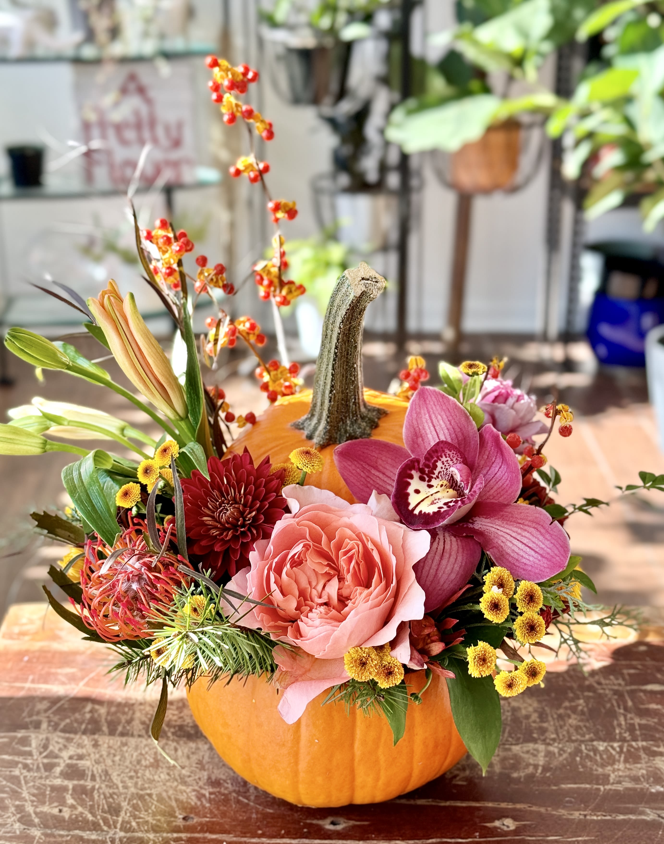 Sally - Next level pumpkin carving... real pumpkin full of beautiful blooms. If you have flower color preferences, please note them in special instructions!  