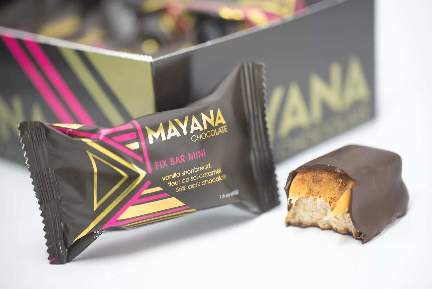 Wrapped chocolate bar with a bitten piece beside it