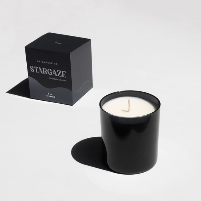 Black candle in a glass jar with a matching box