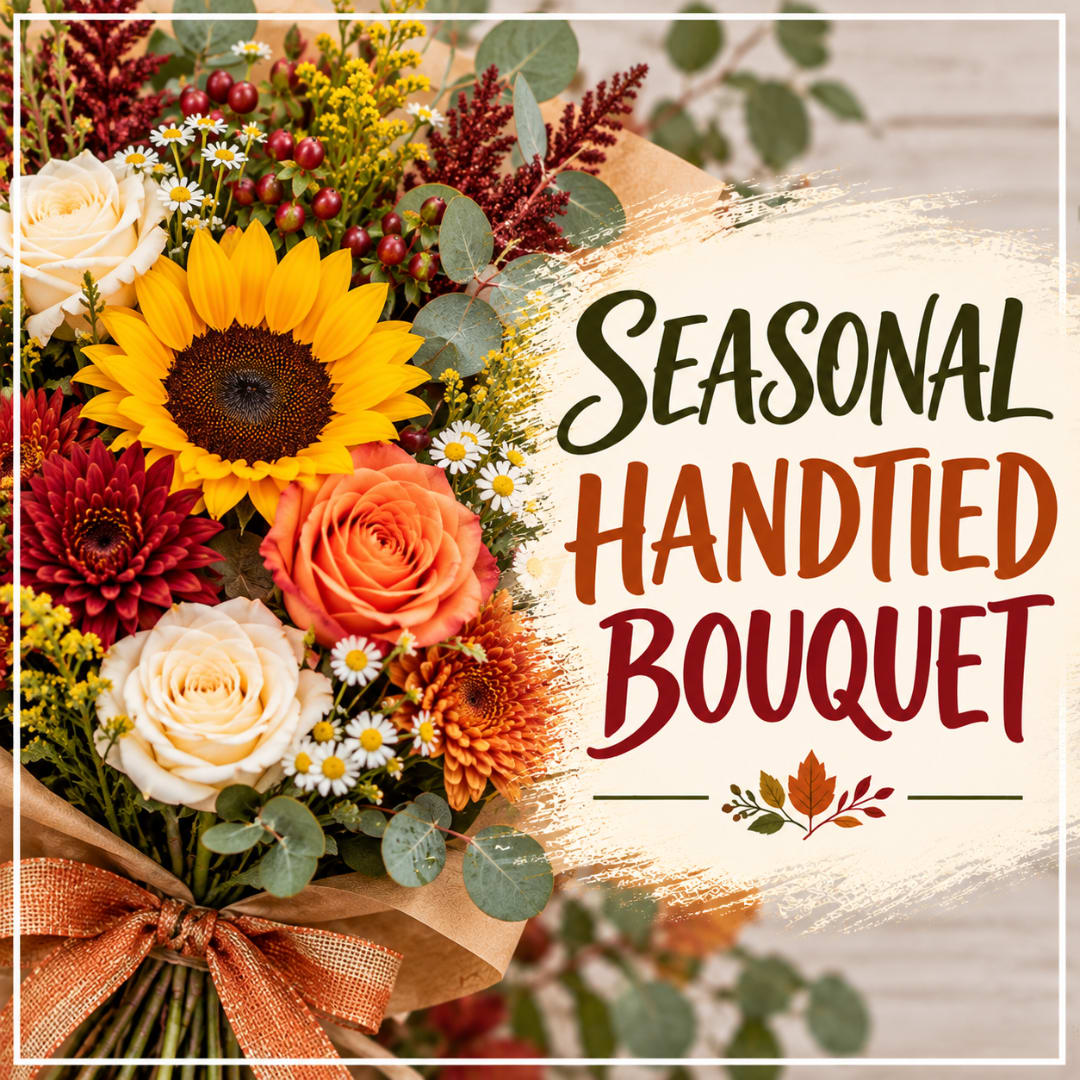 Seasonal bouquet with sunflowers, roses, and autumn flowers tied with a ribbon