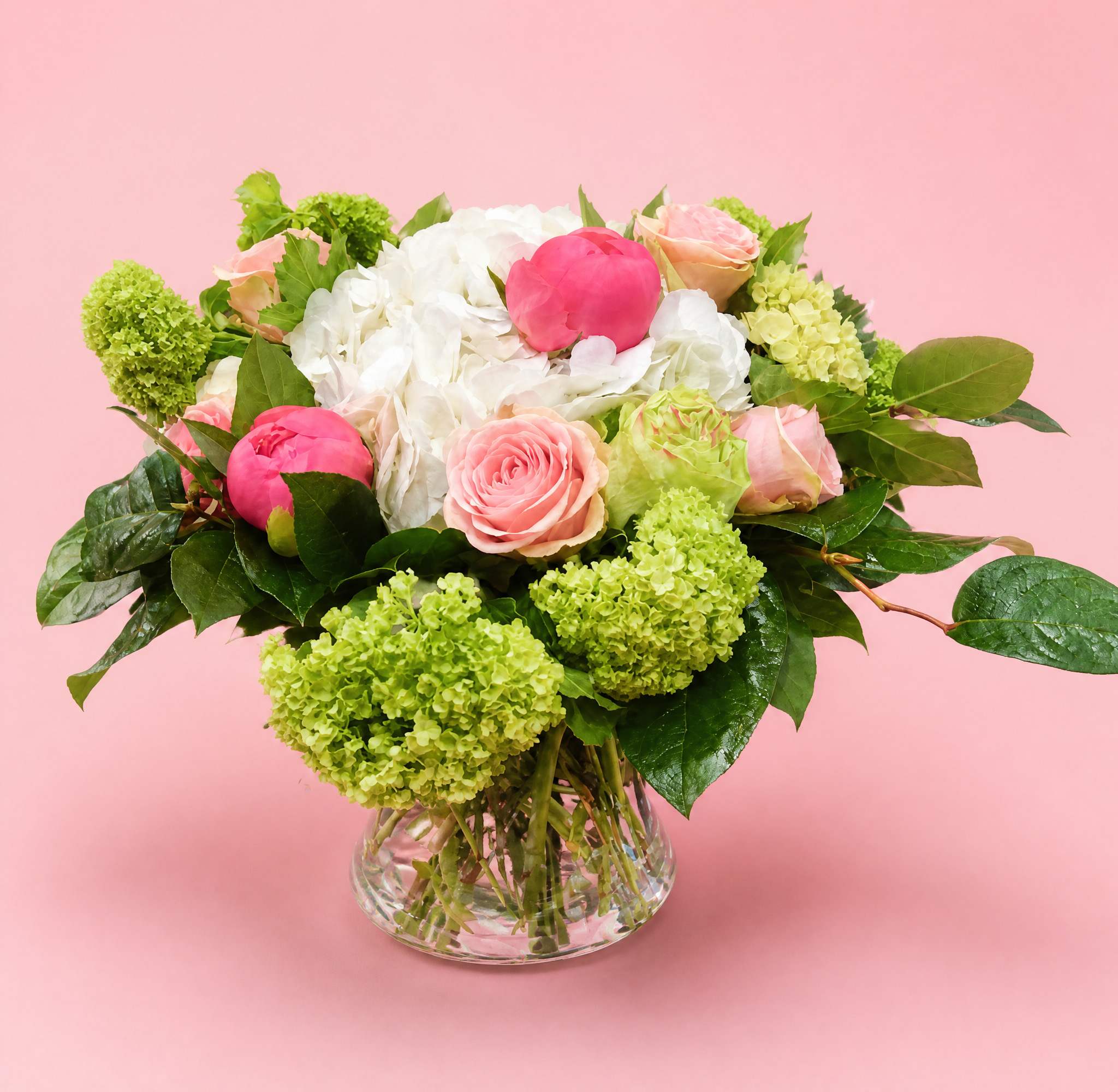 Pink and white flower arrangement in a clear glass vase