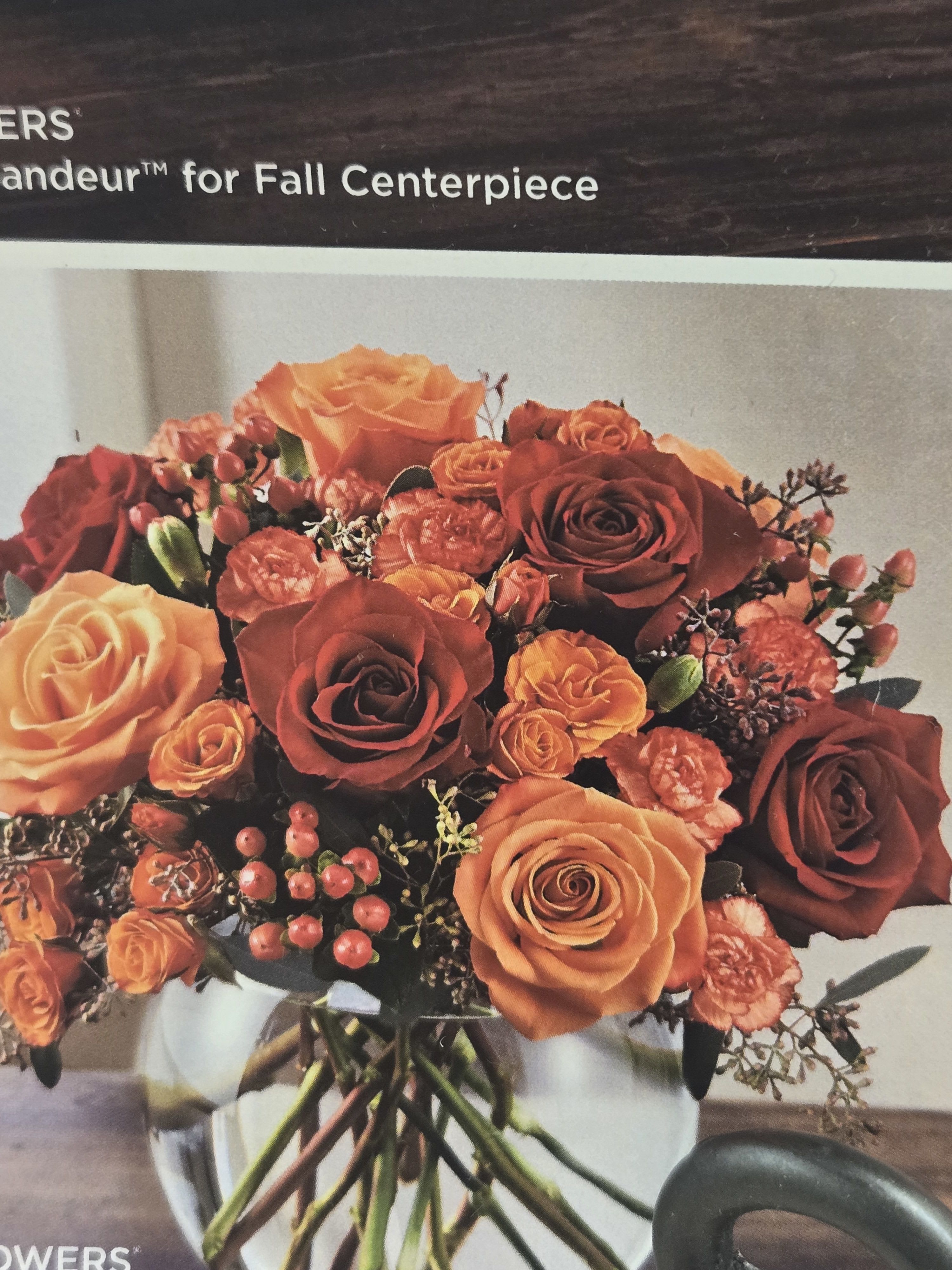 Bouquet of orange and red roses in a glass vase