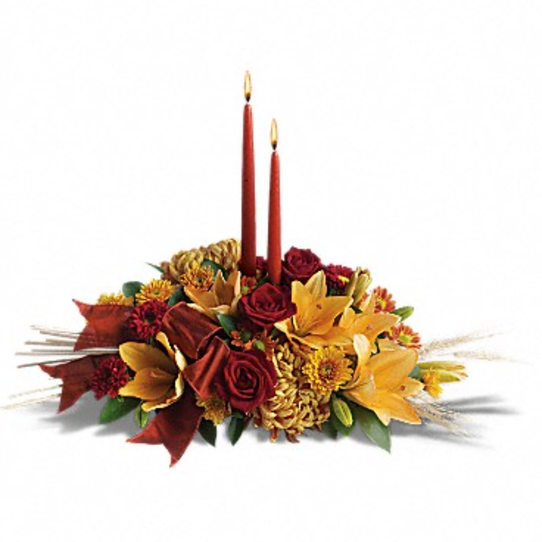 Autumn floral centerpiece with two red taper candles