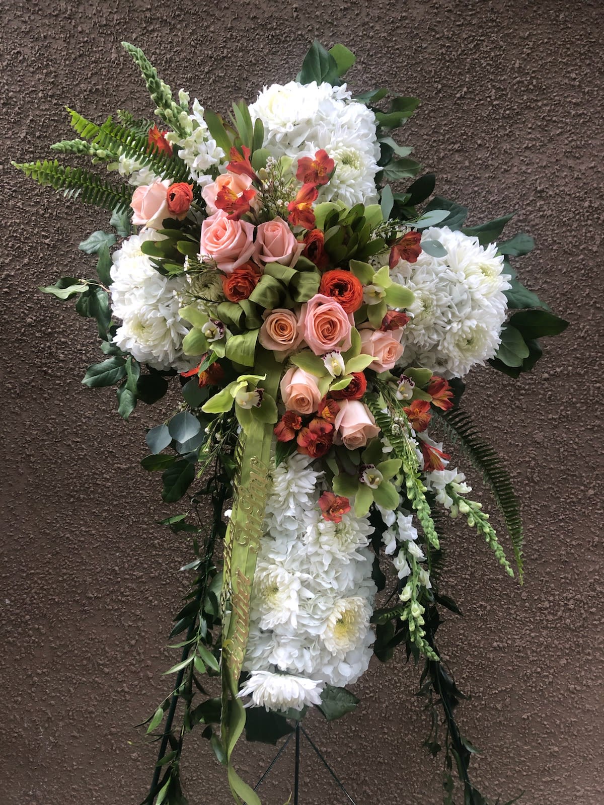 Standing floral spray with white chrysanthemums, pink roses, and orange accents