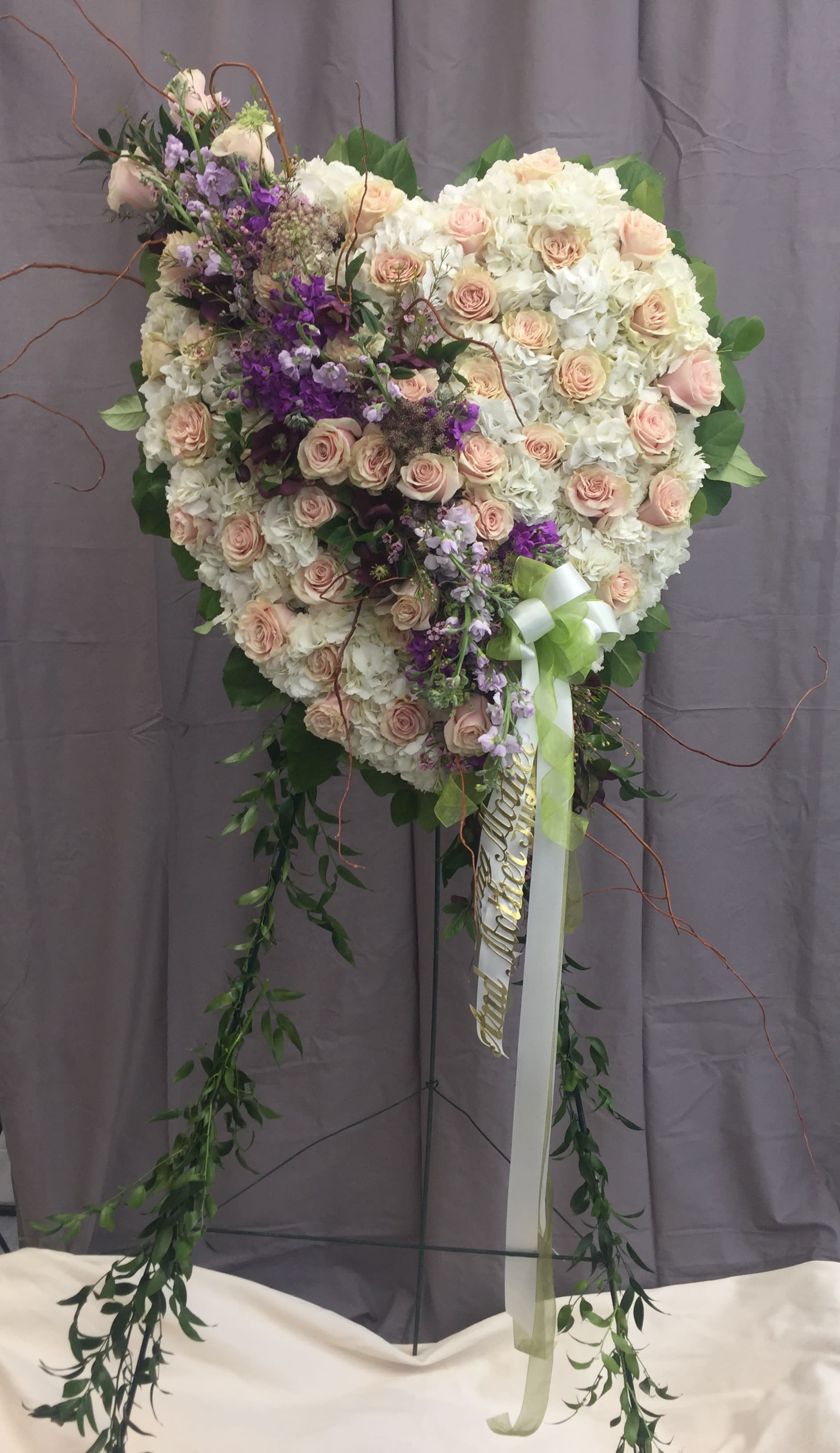 Heart-shaped floral standing spray with pink roses and white blooms