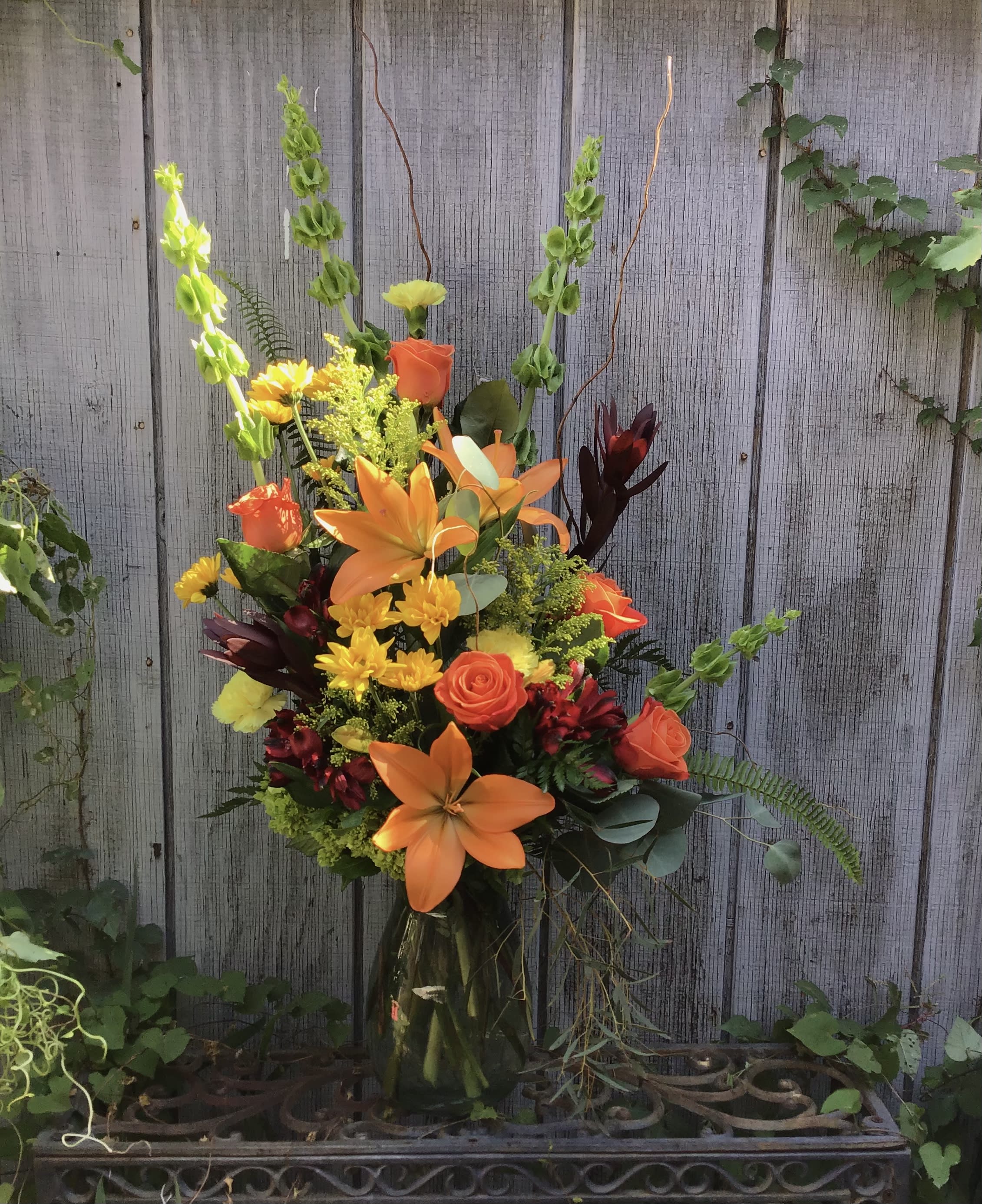Light Of My Life - Bright colored flowers in a unique design with mixed greenery 