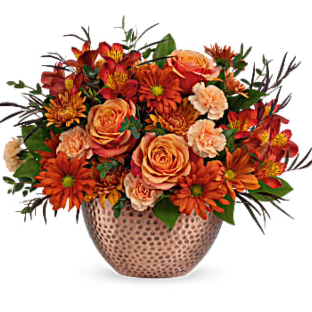 Orange and red mixed bouquet in a textured vase