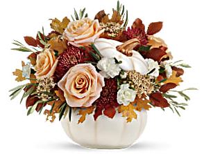Autumn floral arrangement in a white pumpkin vase with roses and mums