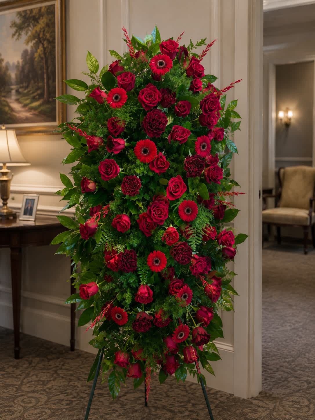 Tall standing floral spray with red roses and gerbera daisies