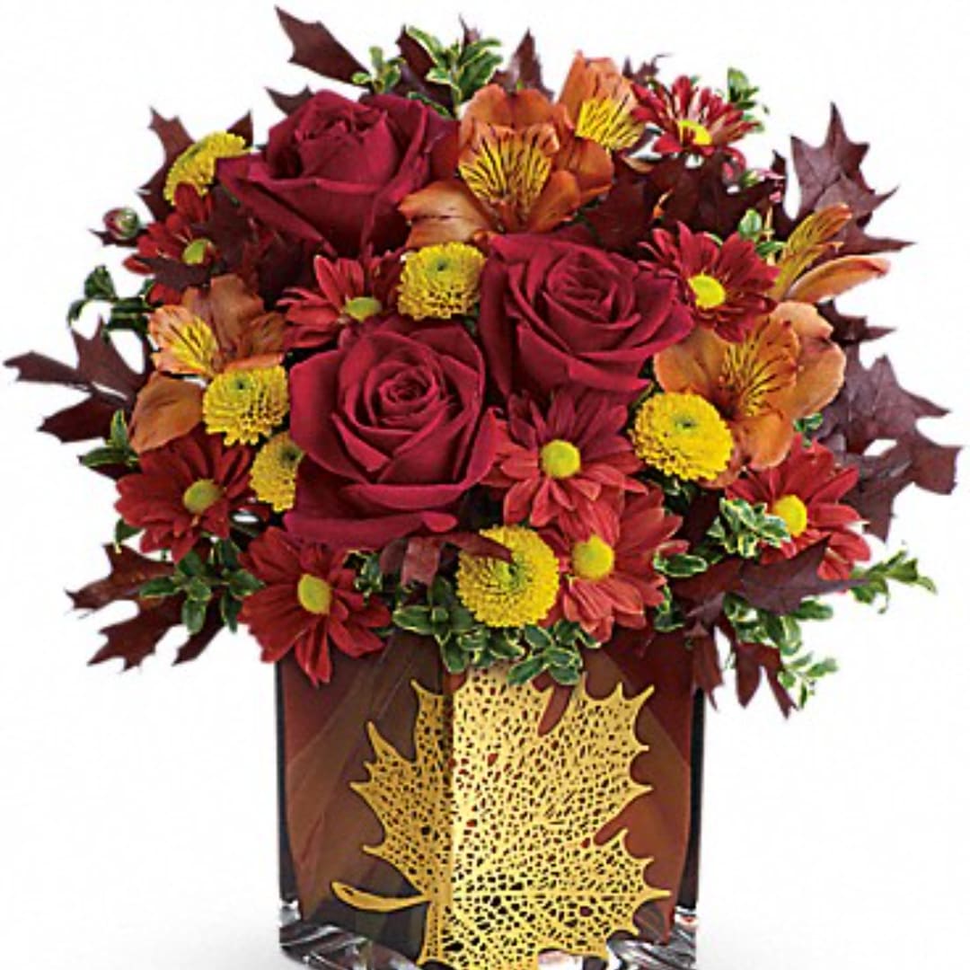 Autumn bouquet of red roses and mums in a decorative vase