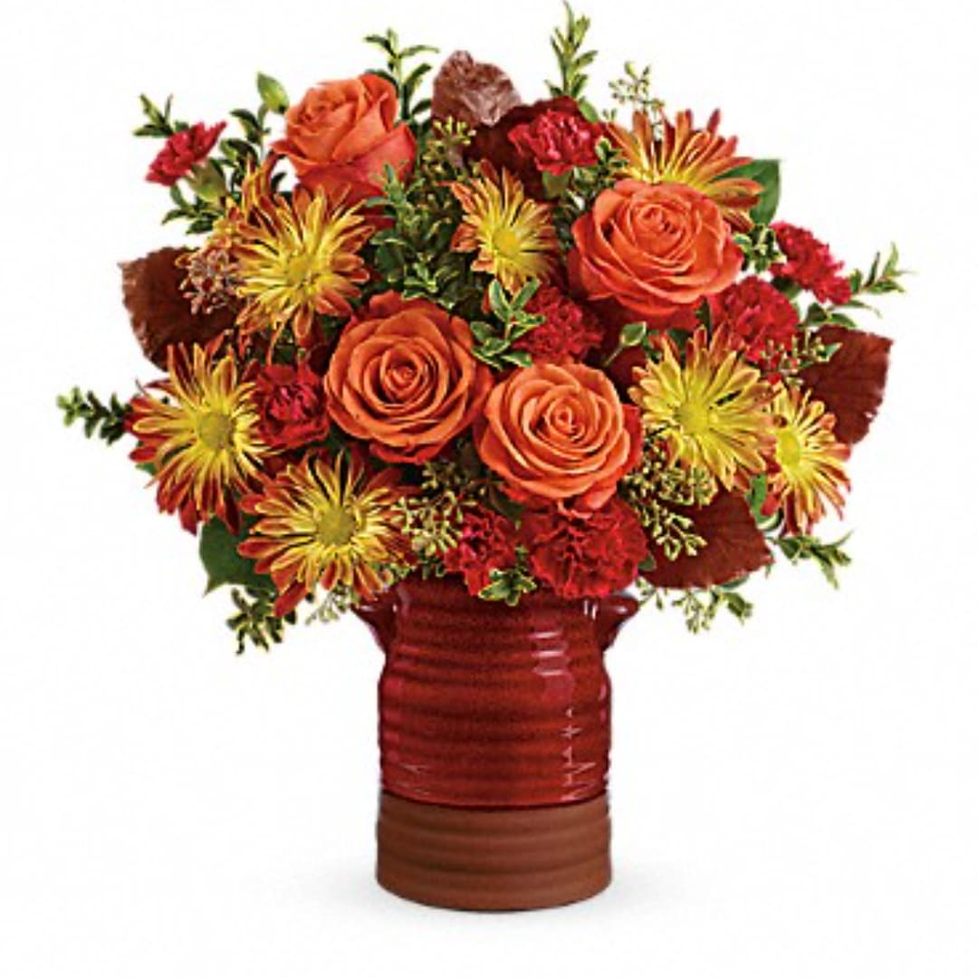 Orange roses and red-yellow mums in a red vase