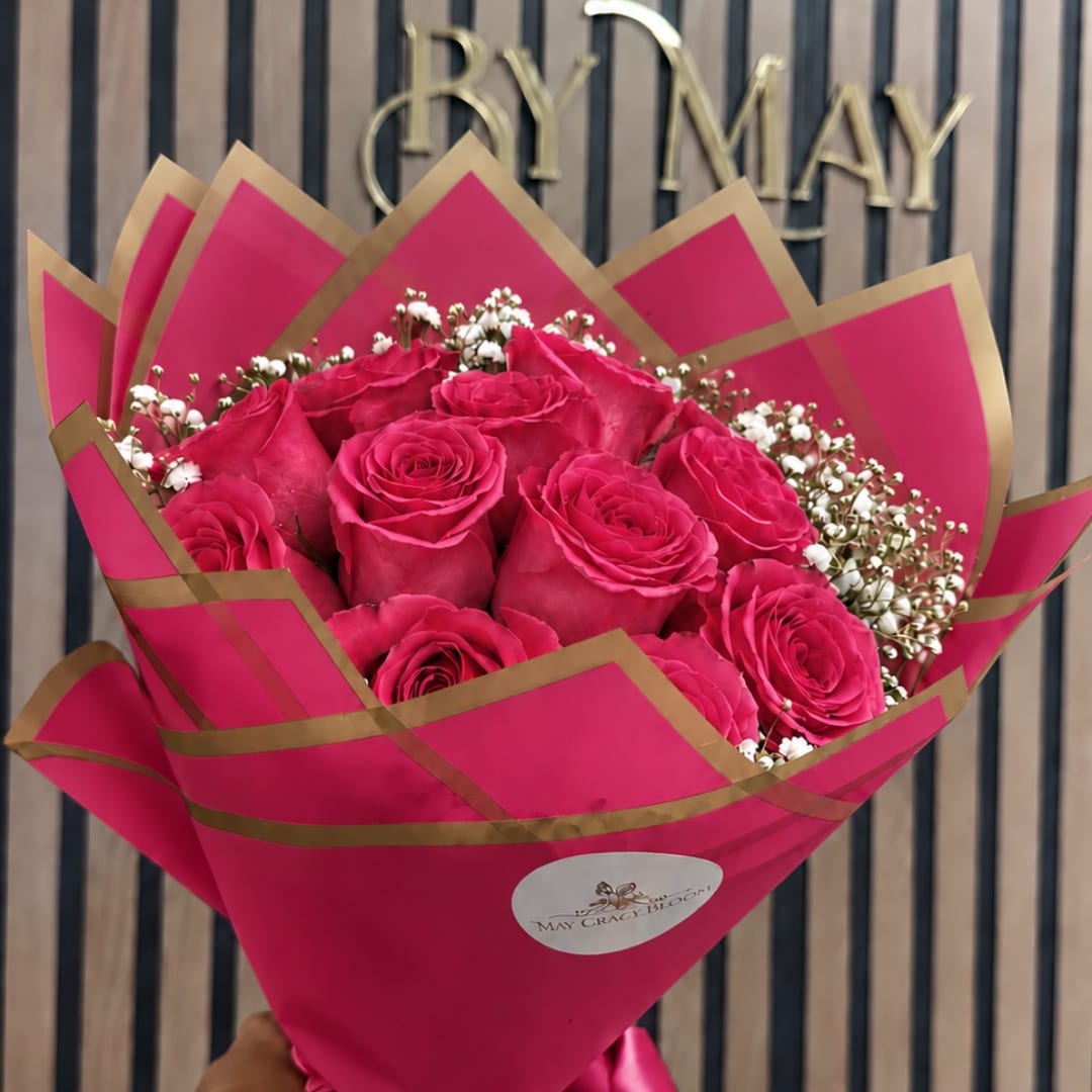 Bouquet of hot pink roses wrapped in bright pink paper