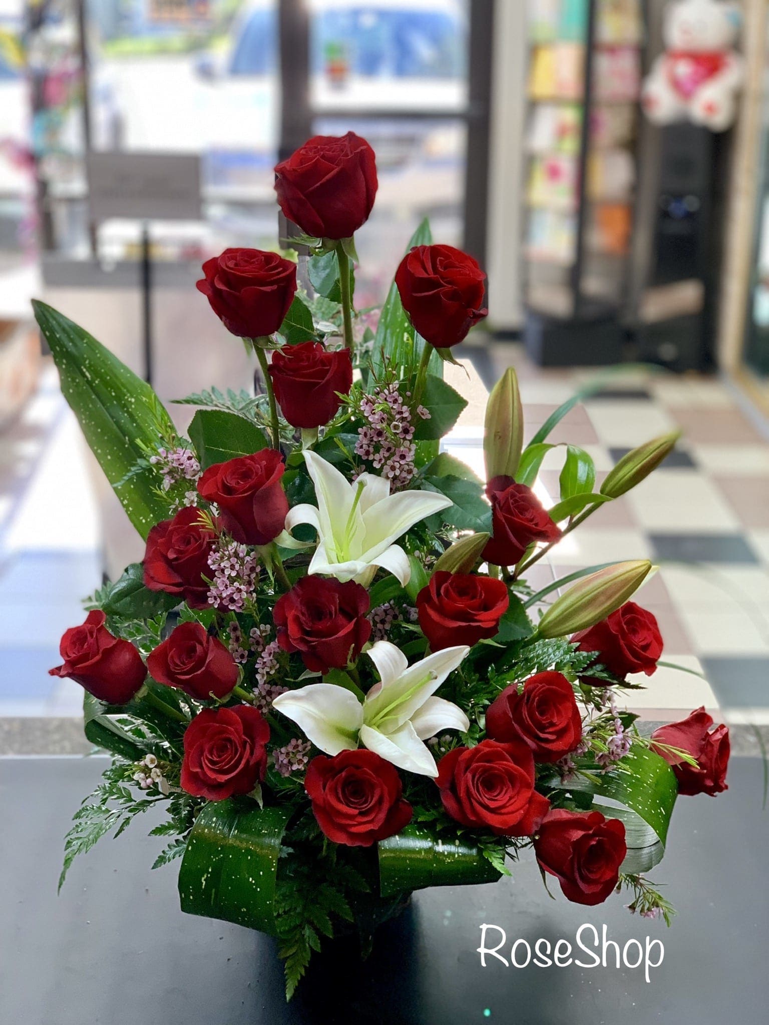 Red roses and white lilies in a compact bouquet