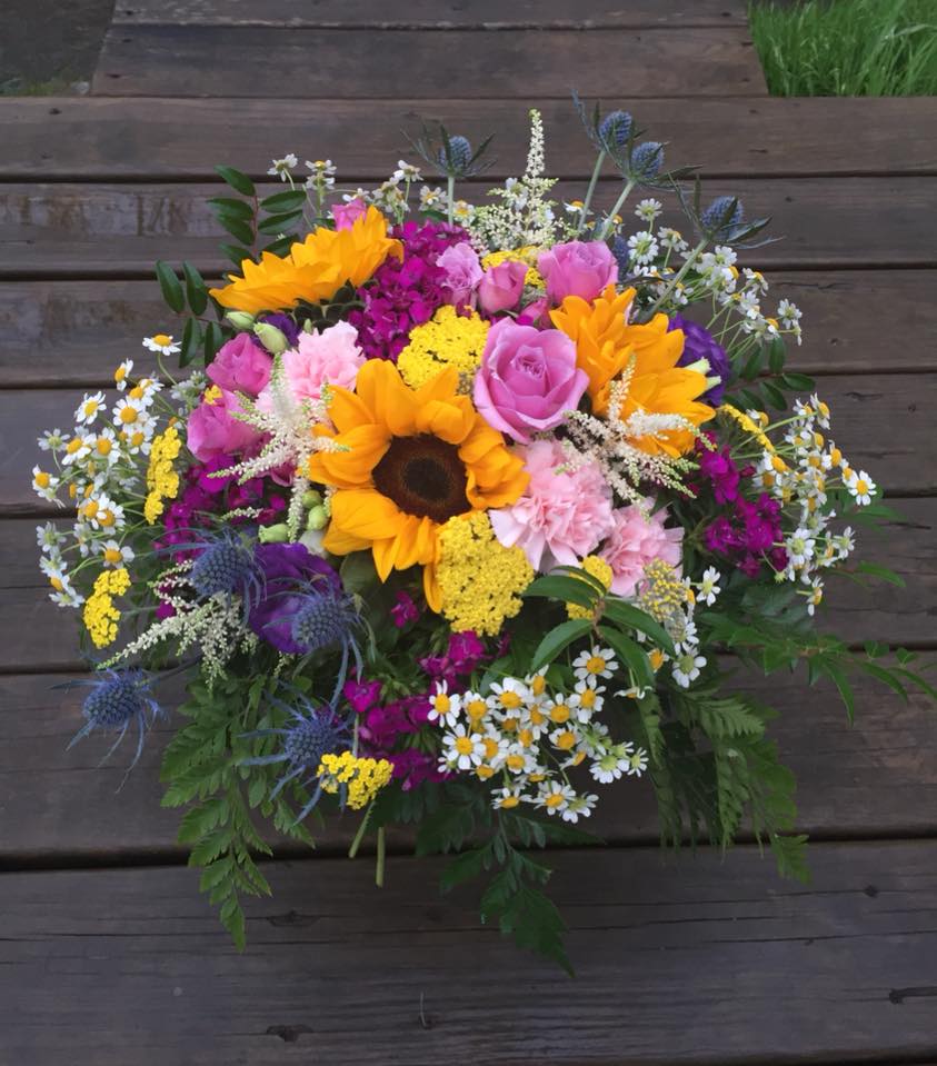 One of a kind, such as you... - Oh! One of our favorite bouquets of all time! Bright, colorful, happy, cheerful, with a dash of wilderness. Surely will draw a smile to one's heart and Soul! Will come nicely wrapped for that extra 'wow' effect! This bouquet makes us sing a happy song! Sing along! https://youtu.be/y6Sxv-sUYtM  *Sunflowers *Carnations *Spray roses *Daisies *Mixed 'wild' flowers and greenery - Please note the colors and flowers may vary upon availability. Flowers come nicely wrapped, NO VASE! 