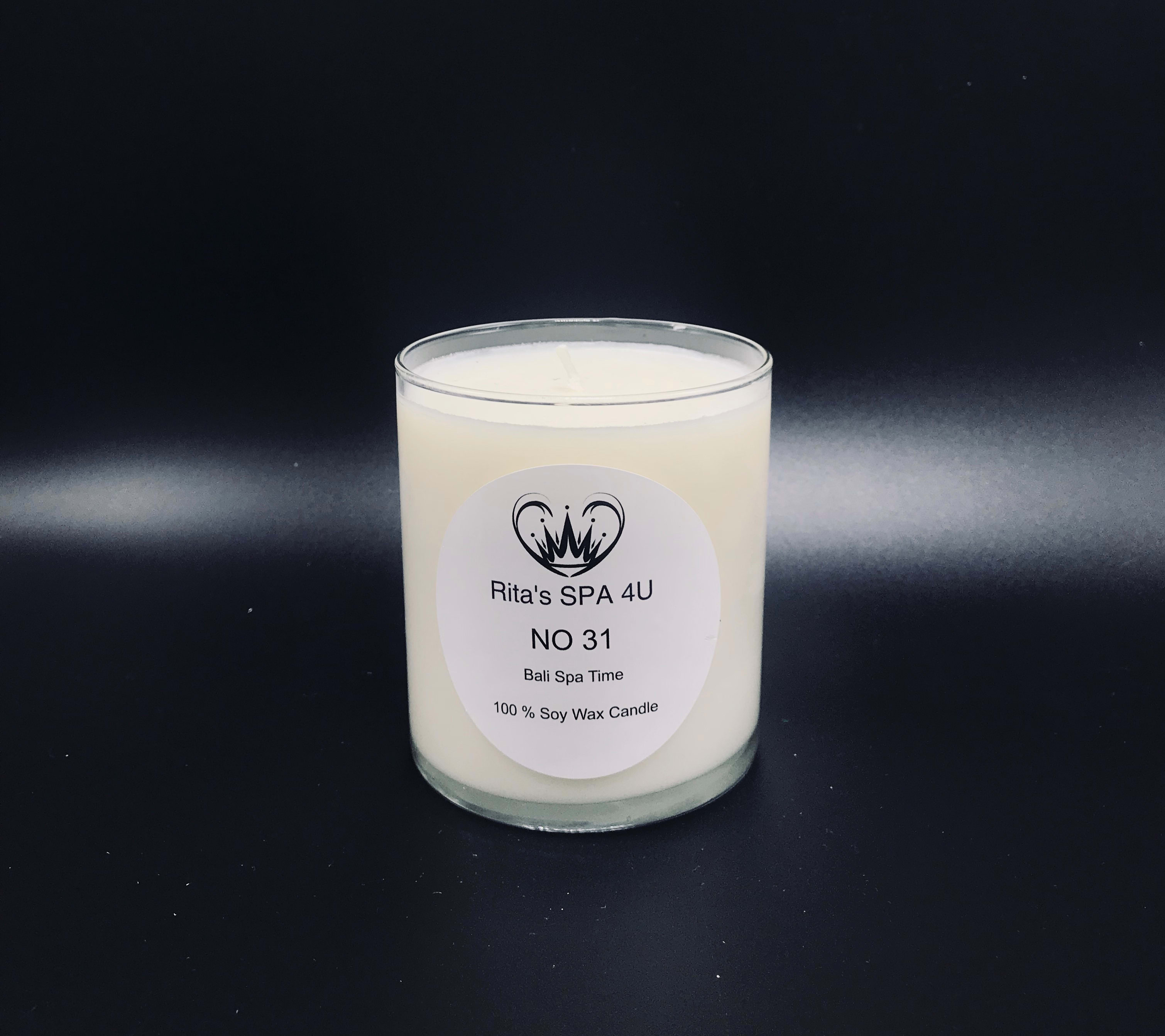 White soy wax candle in a clear glass jar with a printed label