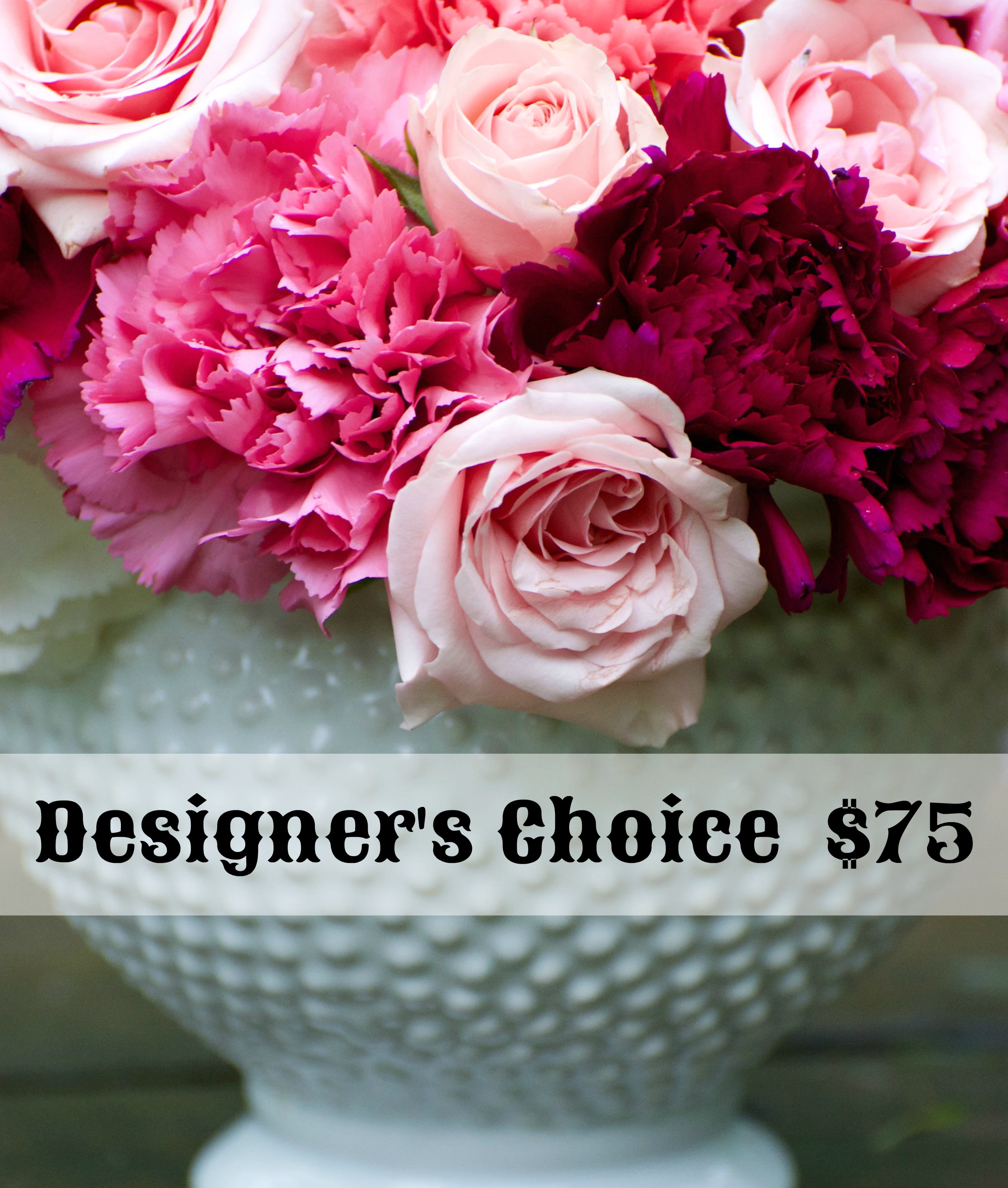 Pink and white roses with magenta carnations in a white vase