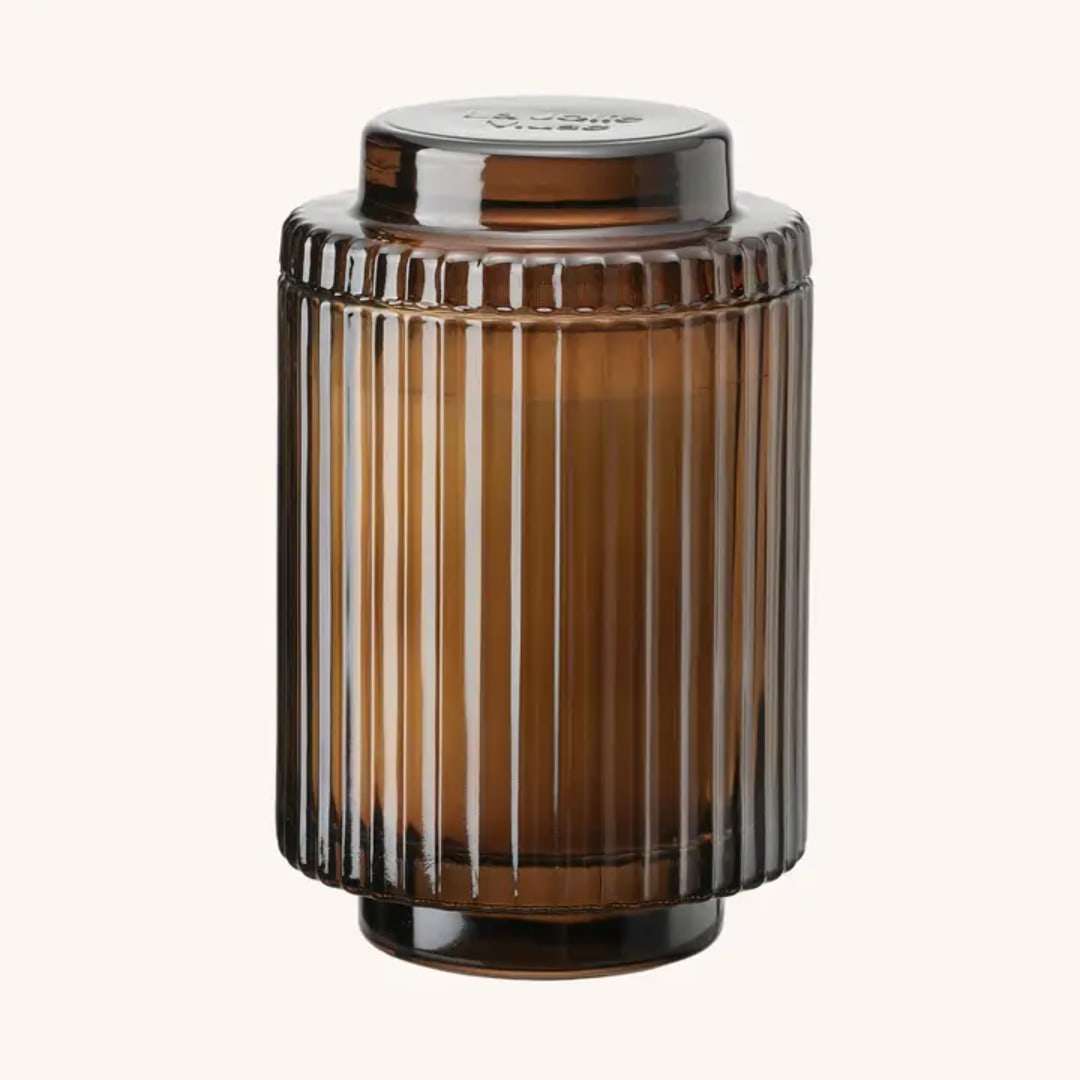 Amber ribbed glass candle jar with a lid