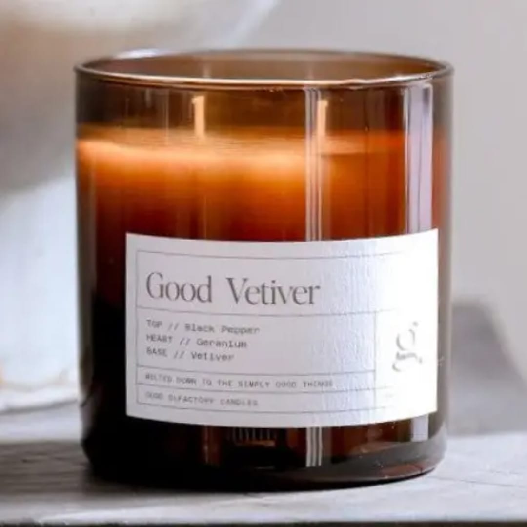 Amber glass candle in a labeled jar