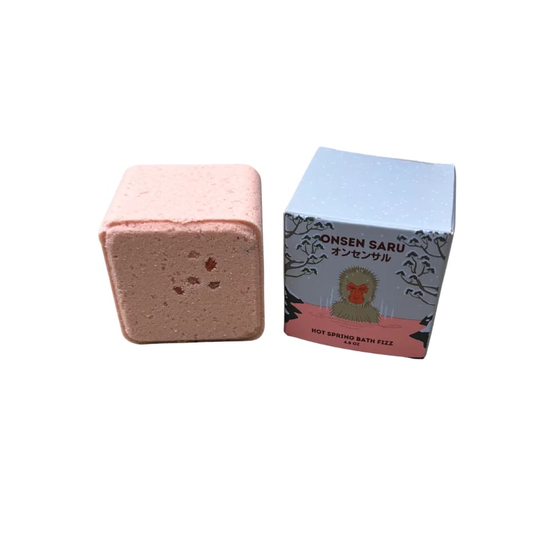 Pink bath fizzy beside its illustrated box