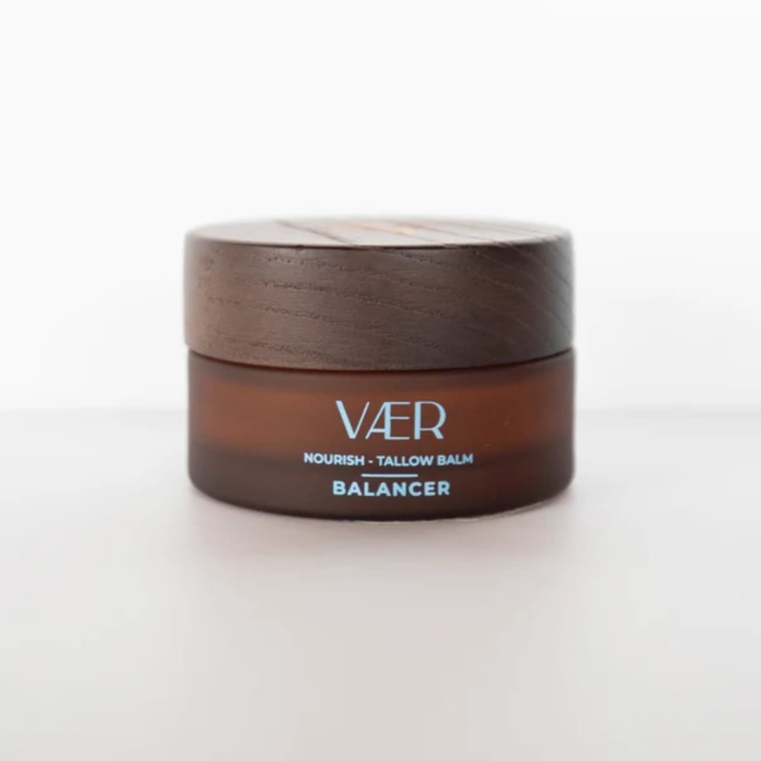 Brown cosmetic balm jar with a wooden lid on a white background