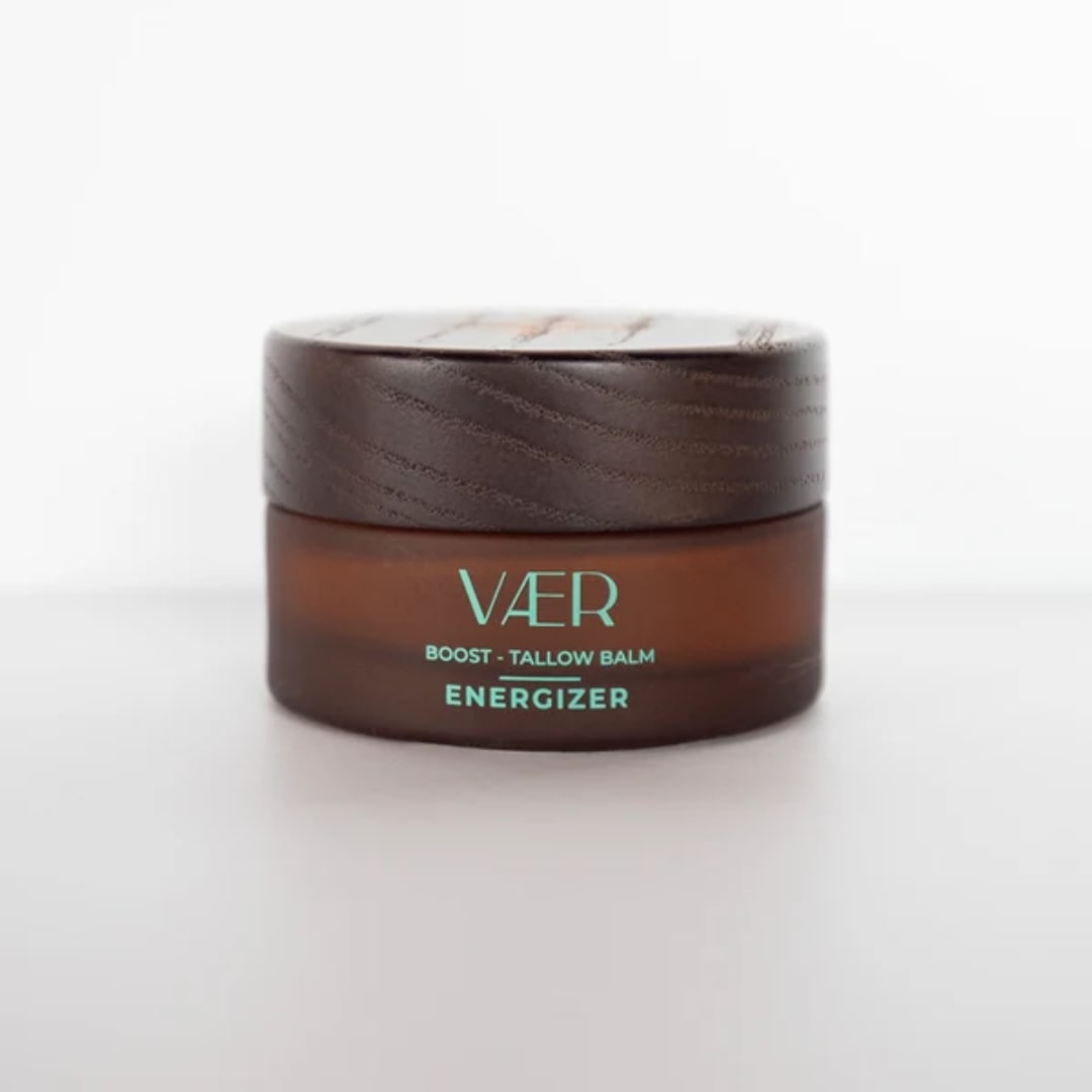 Brown balm jar with a wooden lid on a white background