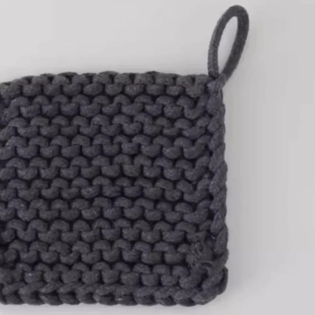 Dark knitted square pouch with a loop handle