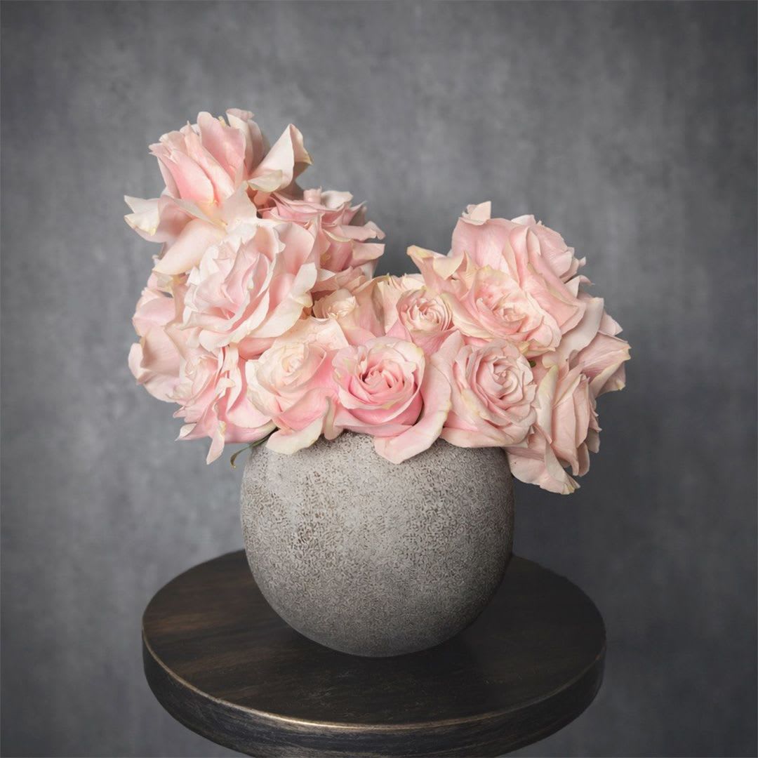 Soft Blush - A delicate arrangement of soft blush roses designed in a modern ceramic vase. Clean, romantic, and effortlessly elegant, this piece highlights the natural beauty of roses with a refined, minimalist style. Perfect for expressing love, appreciation, or gentle moments of care. Custom greeting card included.