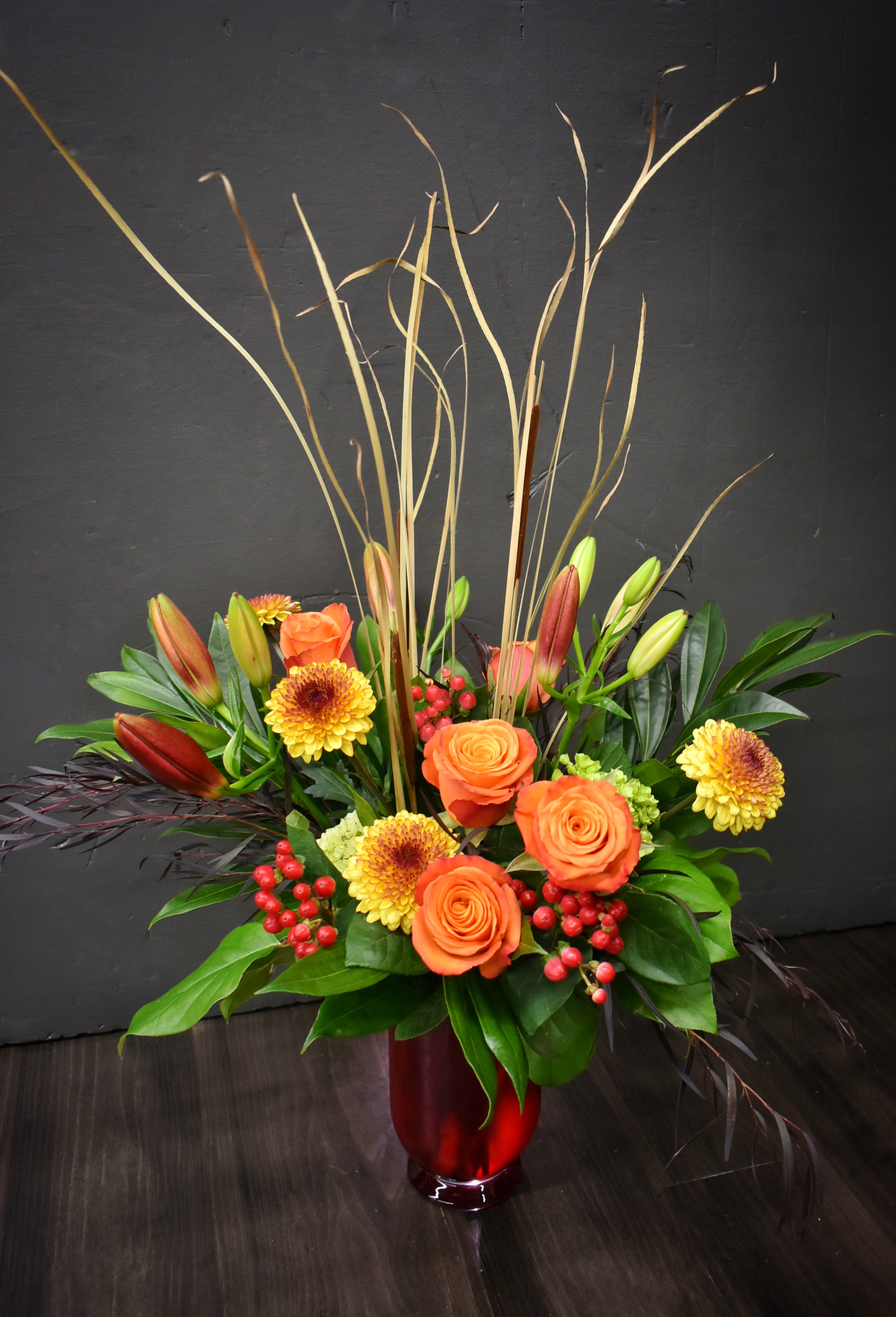 Fall Grandeur - This large and lush bouquet is the perfect gift for the fall season! We’ve filled this deep red glass vase with hydrangeas, roses, lilies and more.