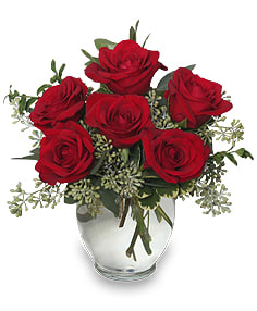 Arrangement of red roses in a clear glass vase