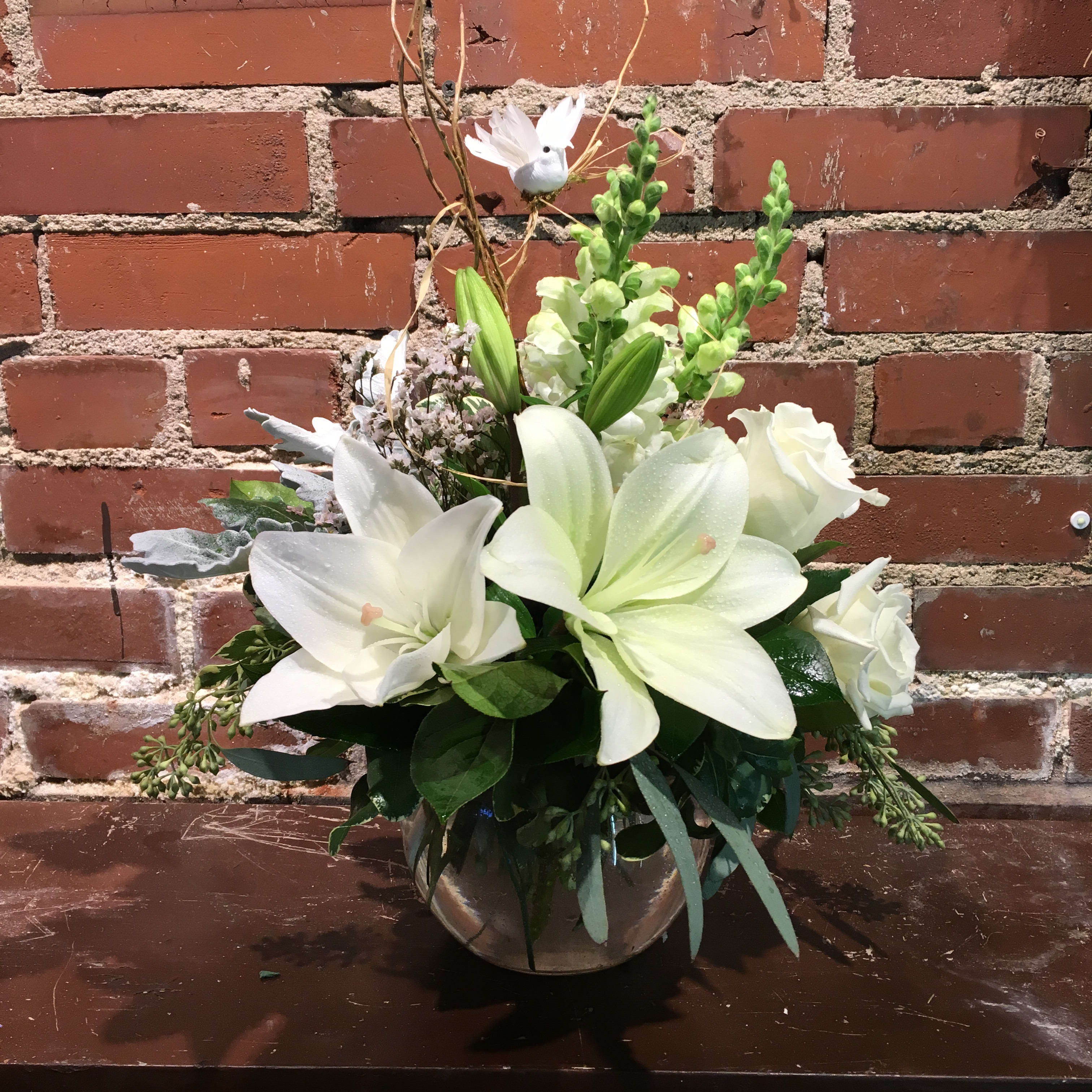 White lily and rose arrangement in a silver vase