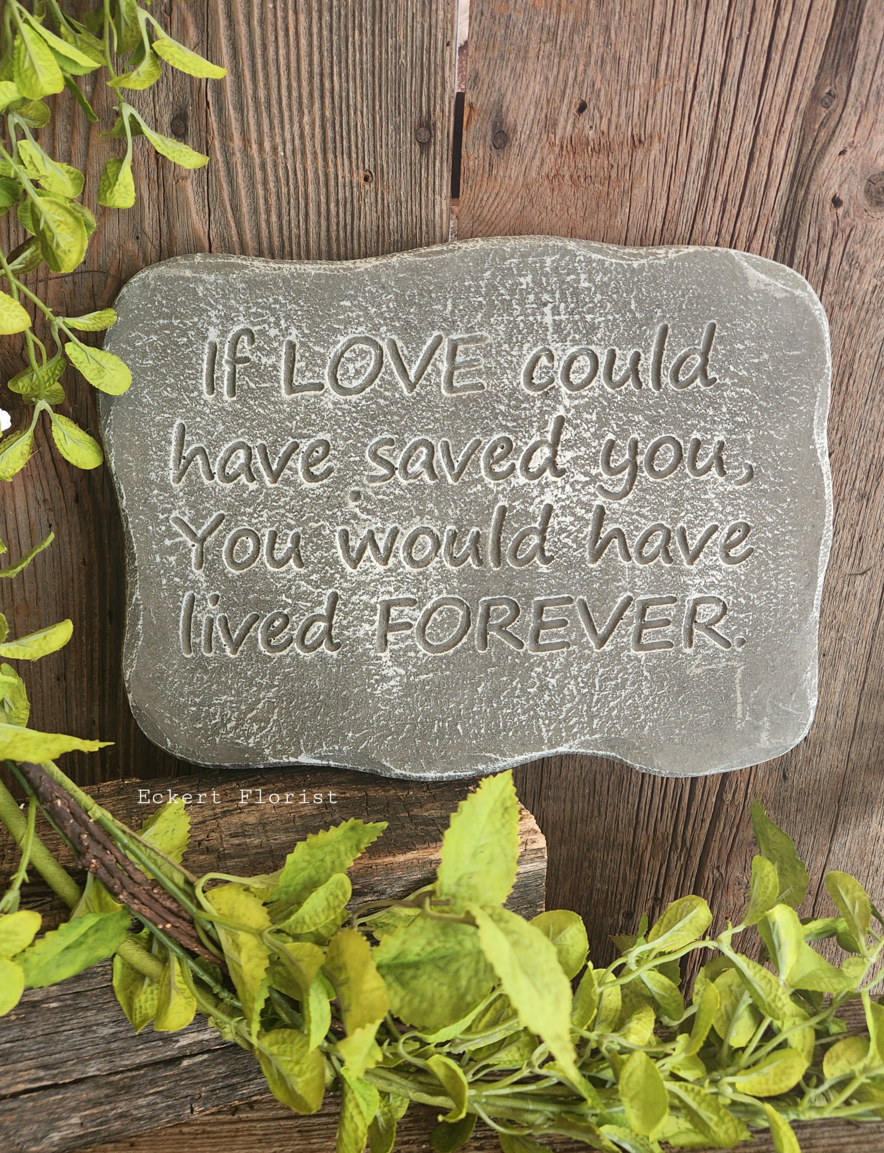 Gray memorial stone with an engraved sympathy quote