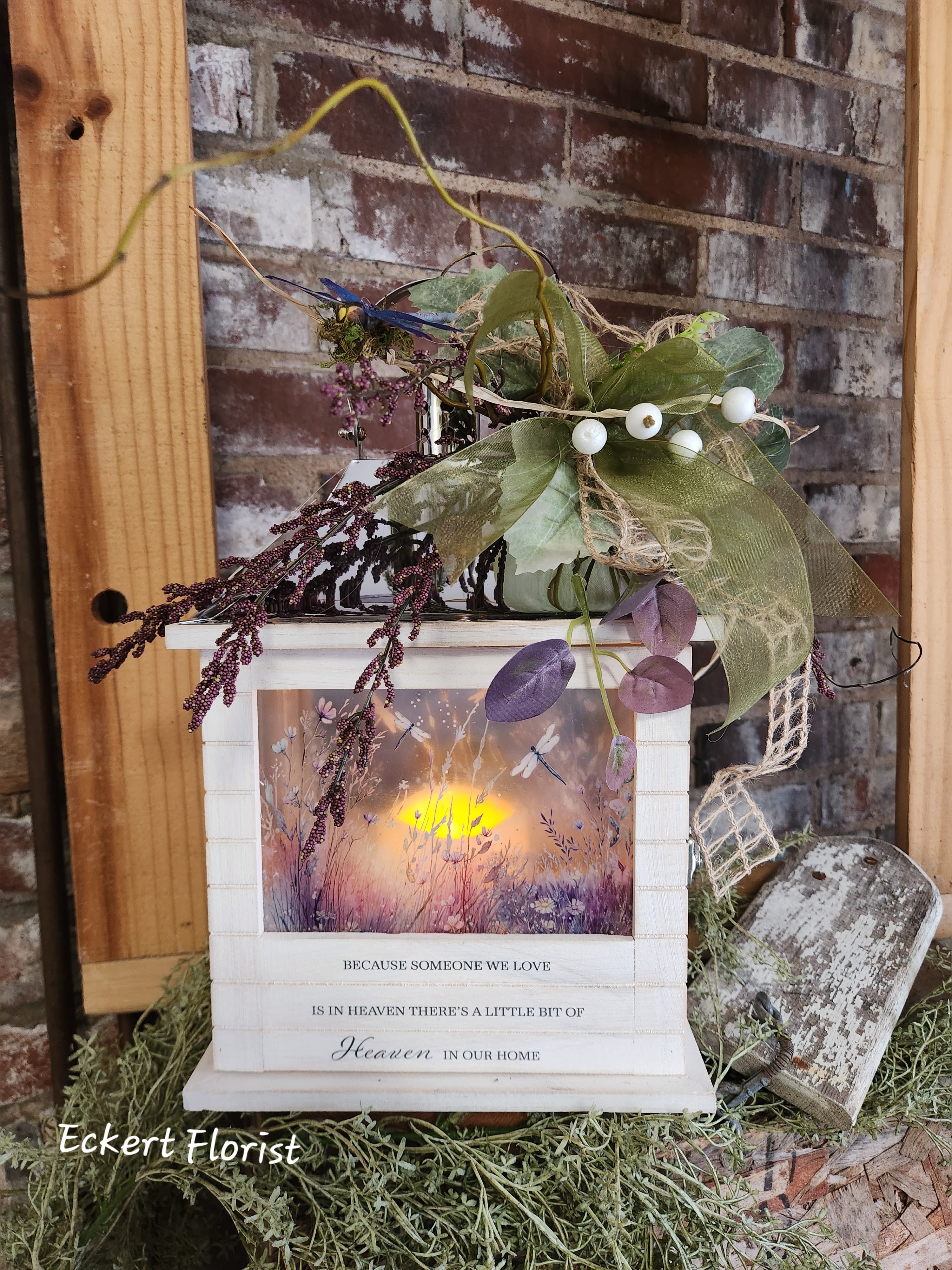 Decorative memorial lantern with faux greenery and berries