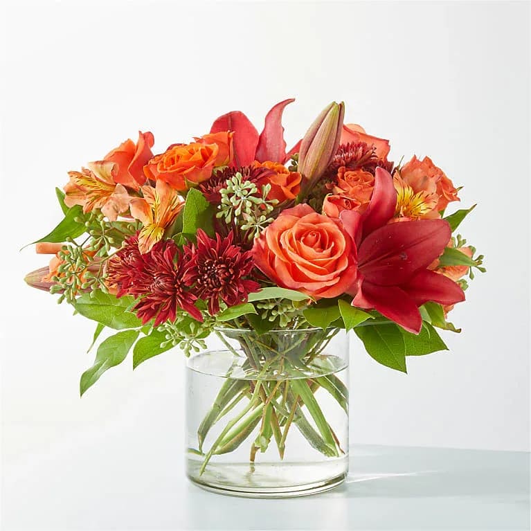 Eckert Florist's FTD Crimson Leaves Bouquet - Capturing the colors of fall foliage, the Crimson Leaves Bouquet is an eye-catching mix of deep reds and oranges, sure to add a smile to your recipient’s day. *Flower variety and colors will vary.