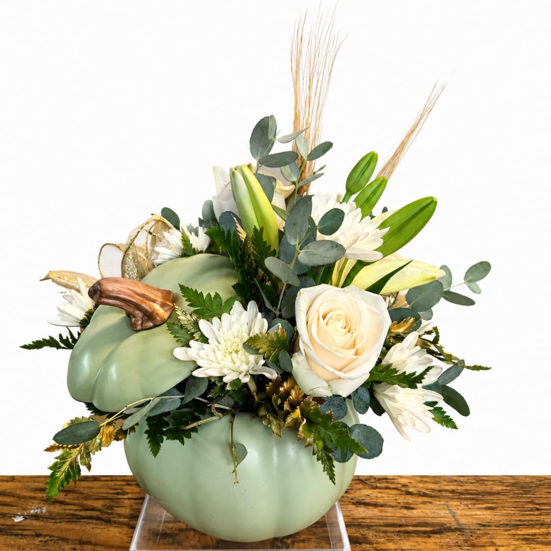 Pumpkin-shaped floral arrangement with white blooms and greenery