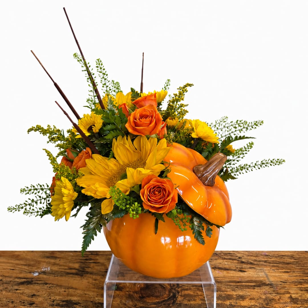 Orange pumpkin vase with yellow flowers and orange roses