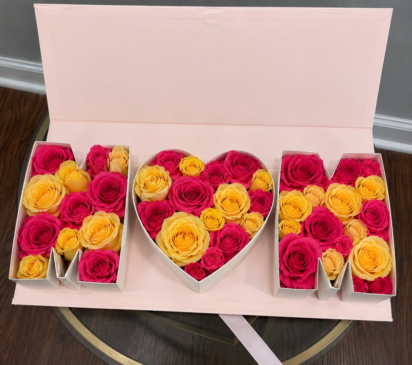 “MOM” rose box  - Celebrate Mom with our signature “MOM” floral box arrangement designed with premium yellow and vibrant pink roses in a luxury keepsake box. This elegant Mother’s Day piece is handcrafted with fresh roses and a modern designer style perfect for gifting. Limited seasonal design by Blum Moon Flowers.