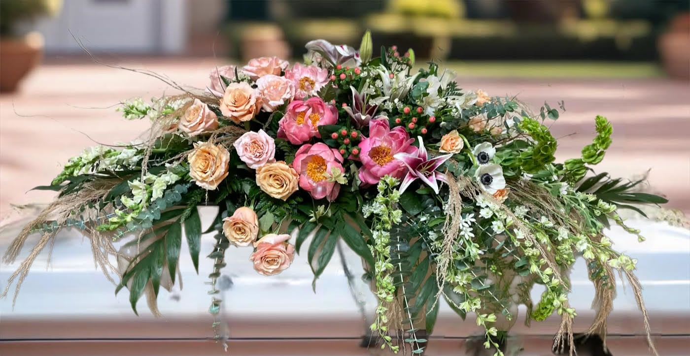 Large floral arrangement with pink and peach roses and lilies