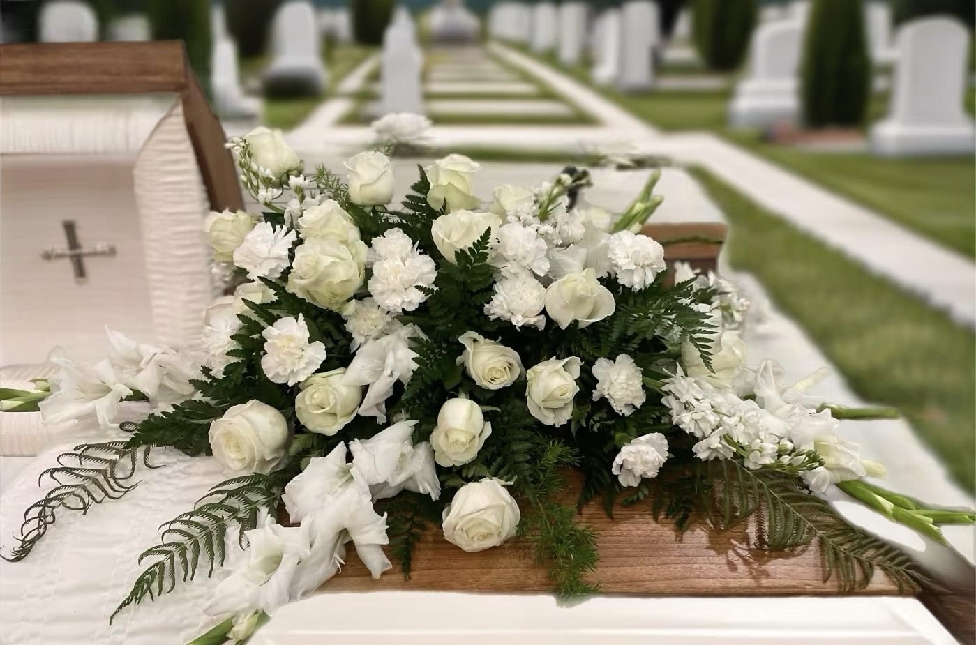 Silken Serenity Casket Spray  - Gracious, innocent and elegant. This beautiful half casket spray is a lovely way to pay tribute to someone who will always remain in your heart. 