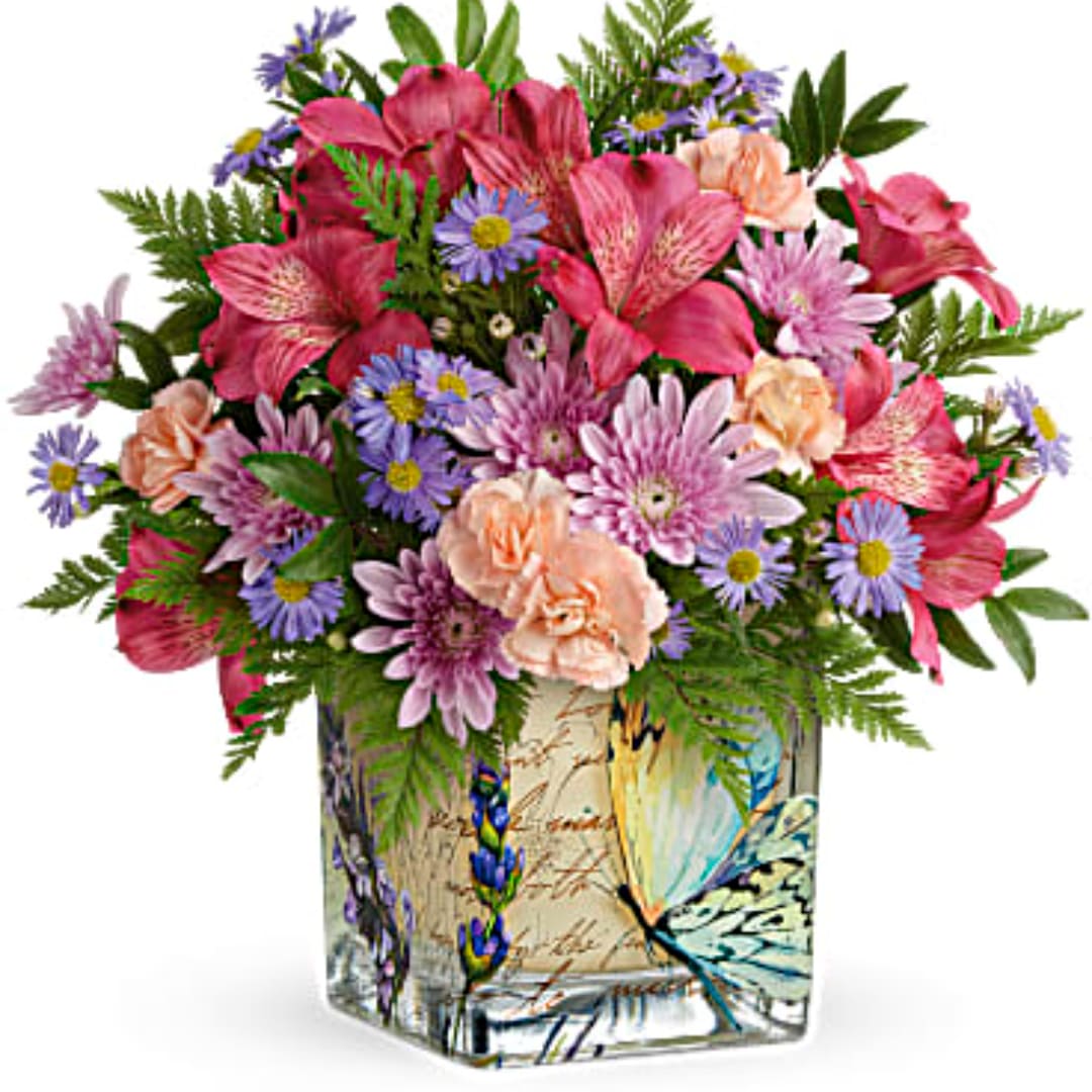 Mixed pink and purple bouquet in a decorative square vase