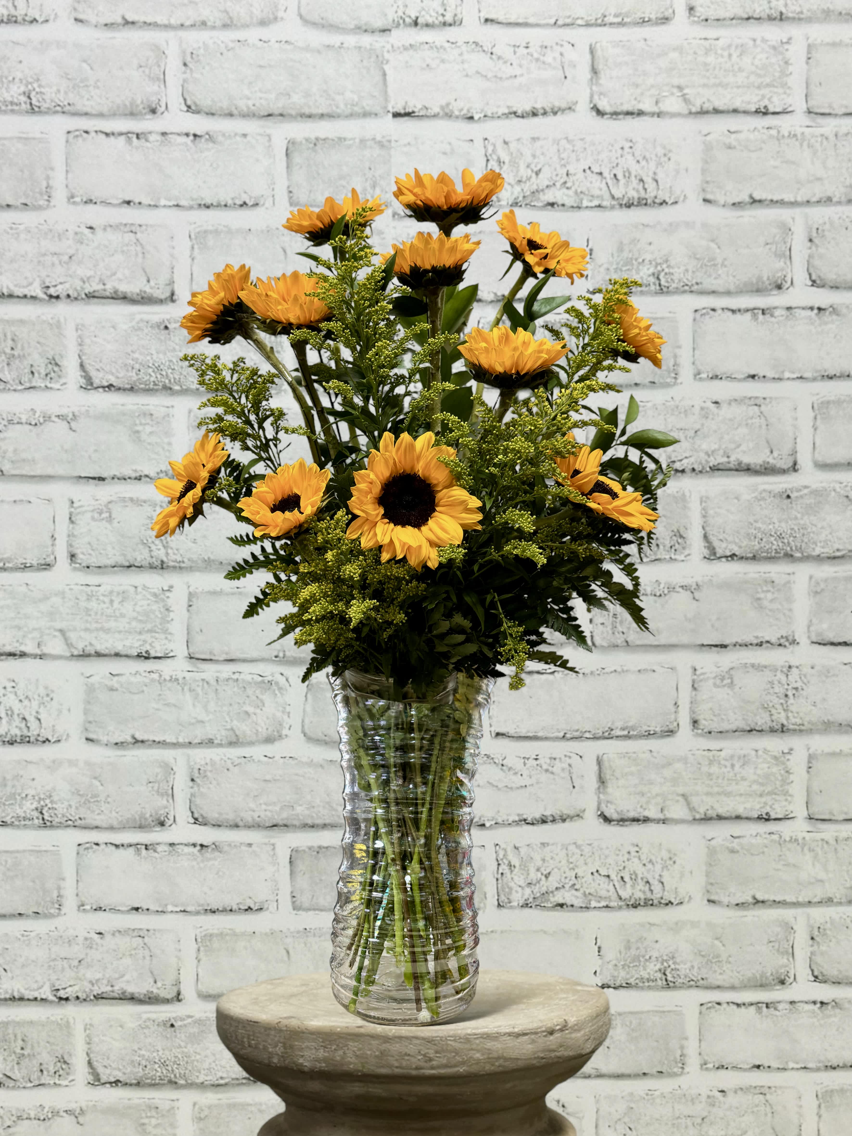 Sunflower arrangement in a clear glass vase
