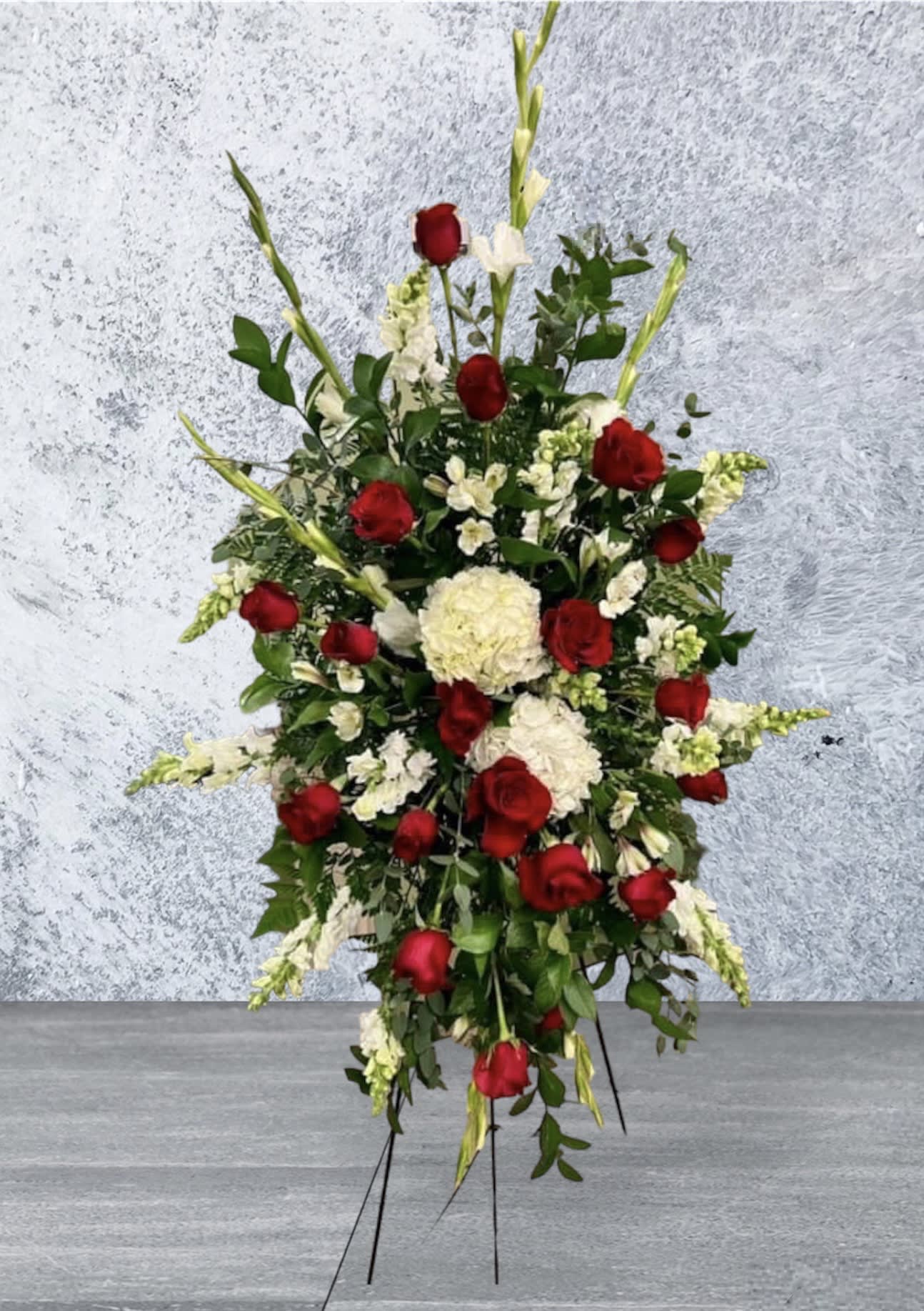 Tall standing floral spray with red roses and white flowers