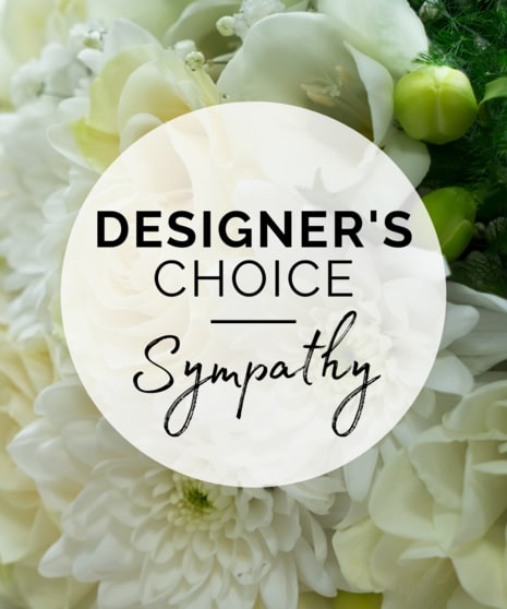 White floral arrangement with a sympathy label