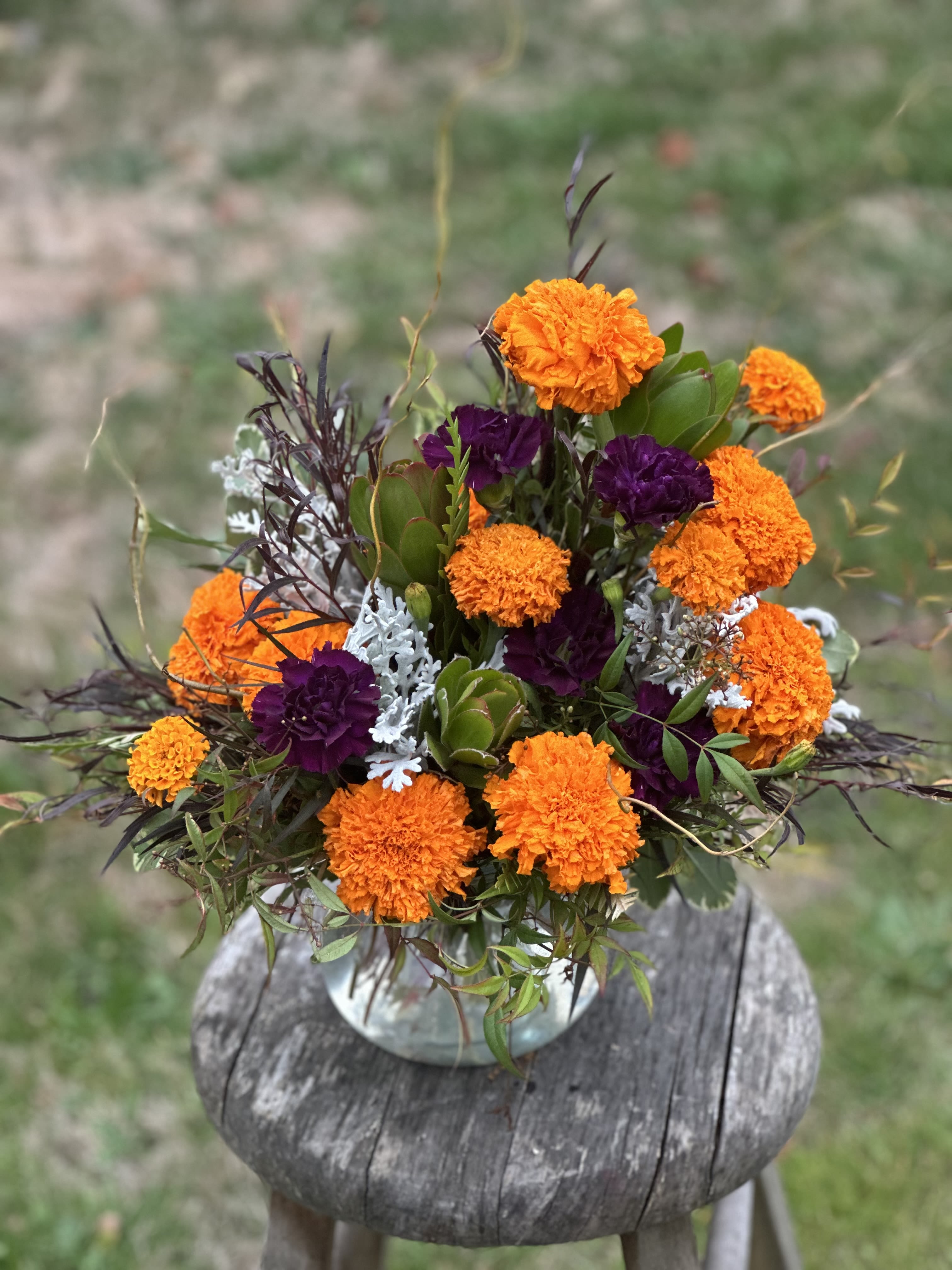 Orange and purple flower arrangement in a vase