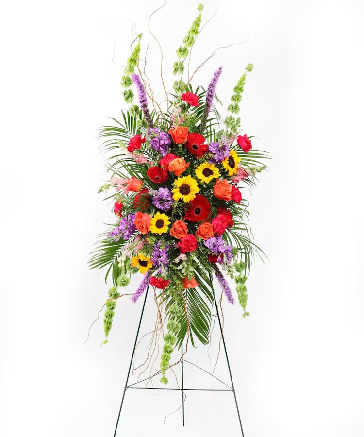 Tall standing floral spray with sunflowers, roses, and gerbera daisies