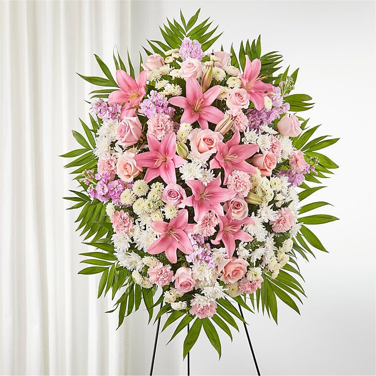 Large pink and white floral standing spray on an easel