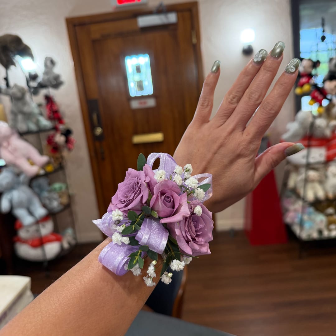 Lavender rose wrist corsage with ribbon and baby's breath
