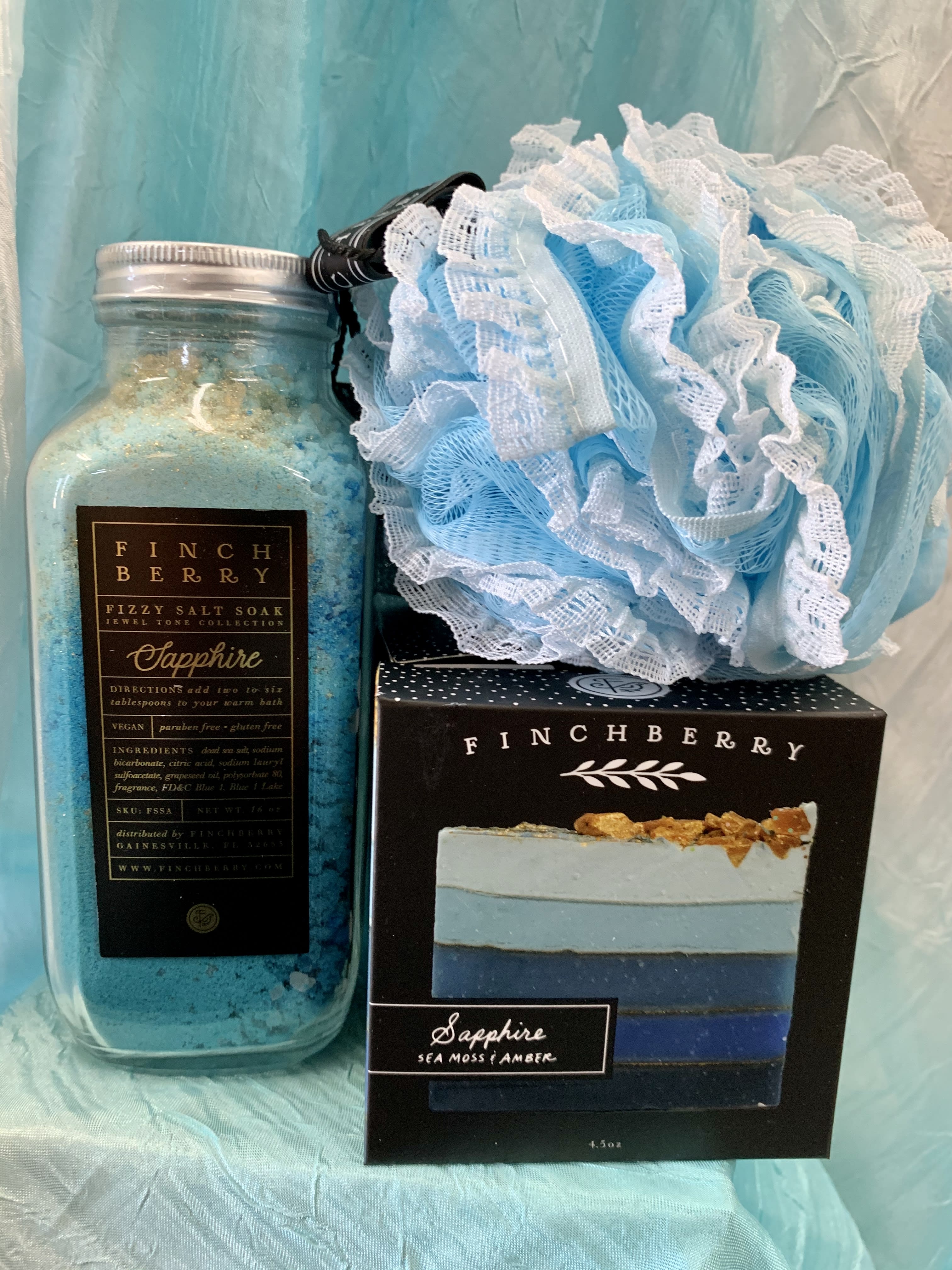 Blue bath soak jar with a matching soap box and bath pouf