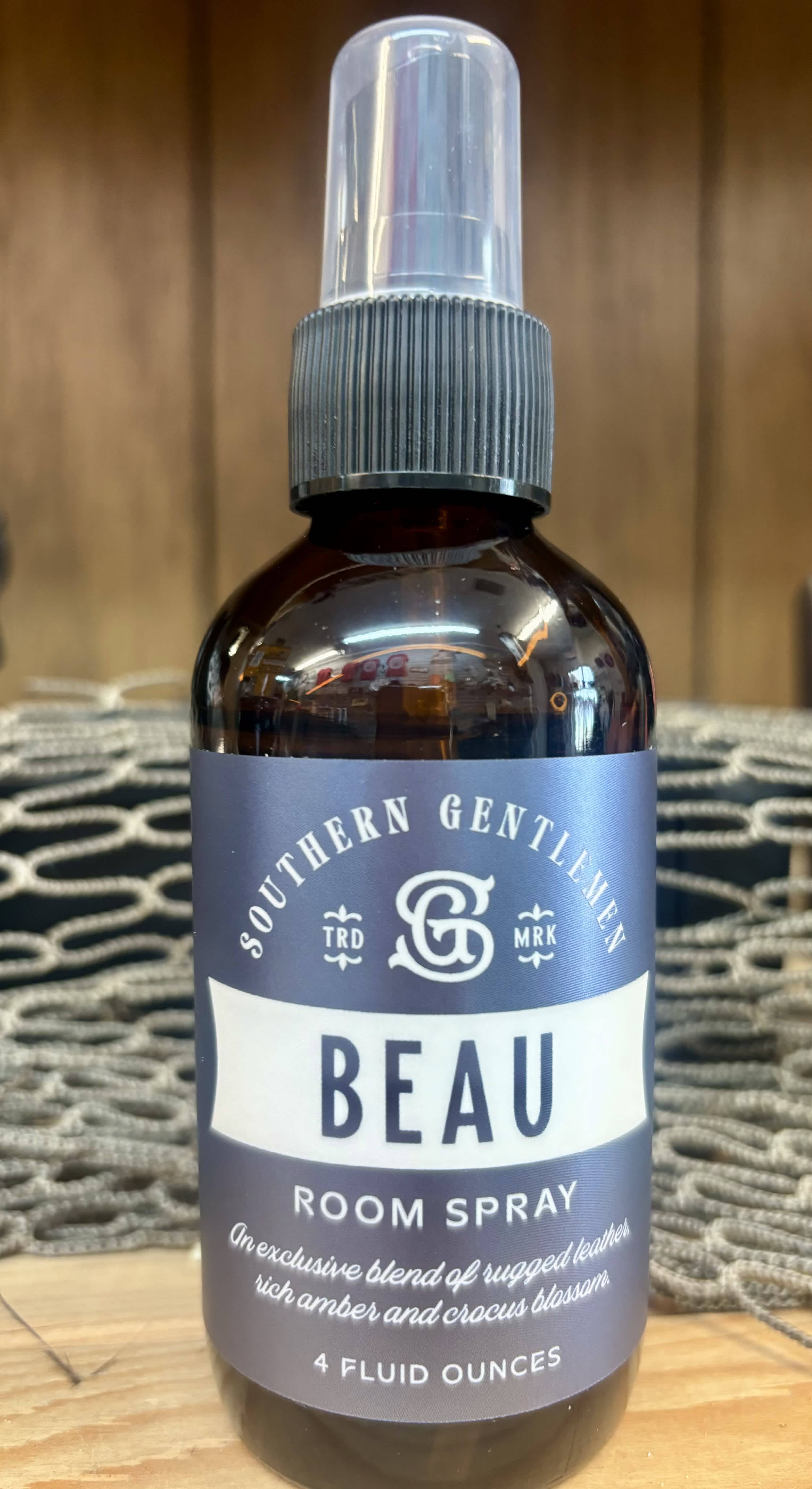 Bottle of Beau room spray with a clear cap and gray label