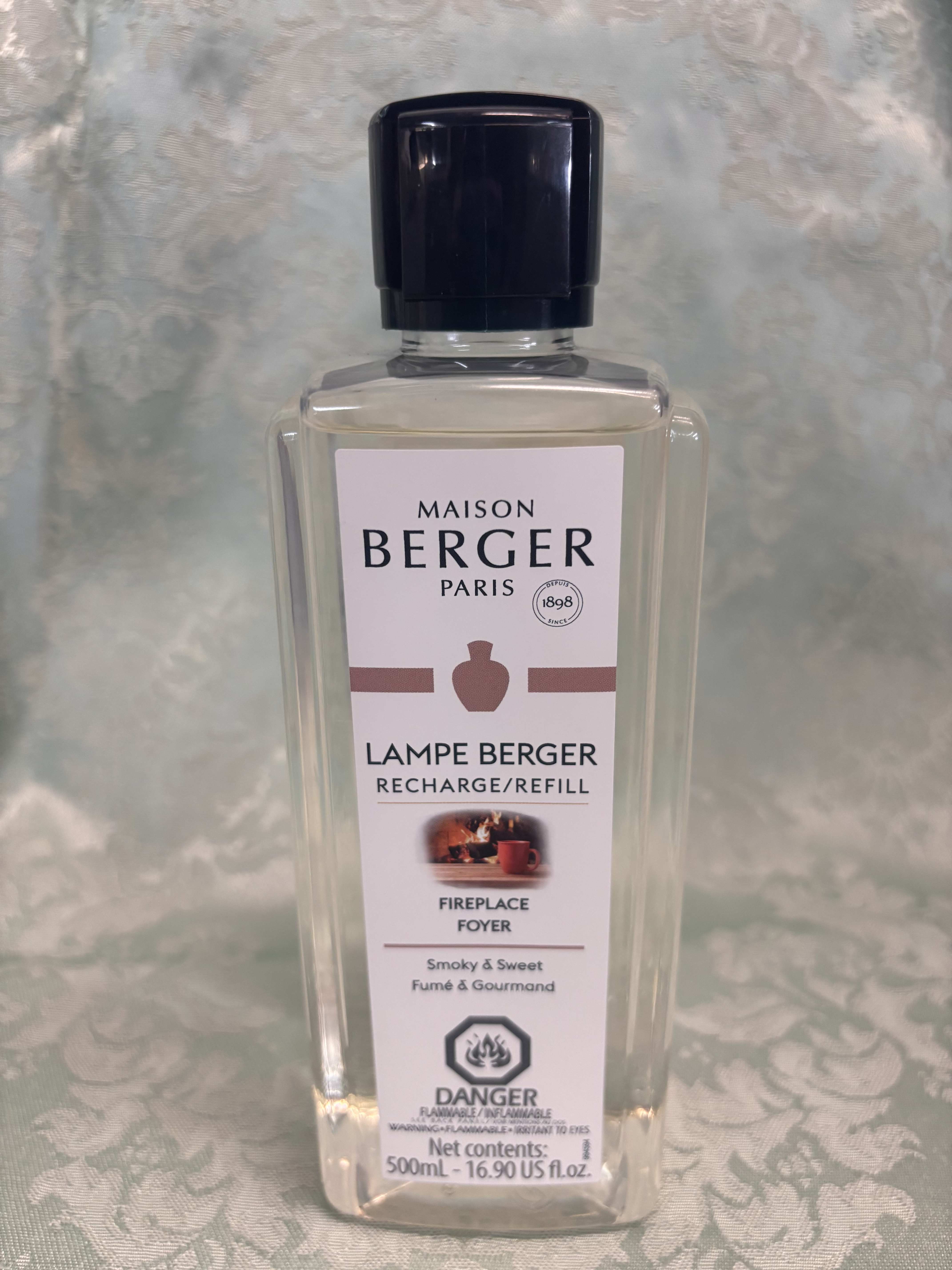 Clear bottle of Maison Berger lamp refill with a black cap