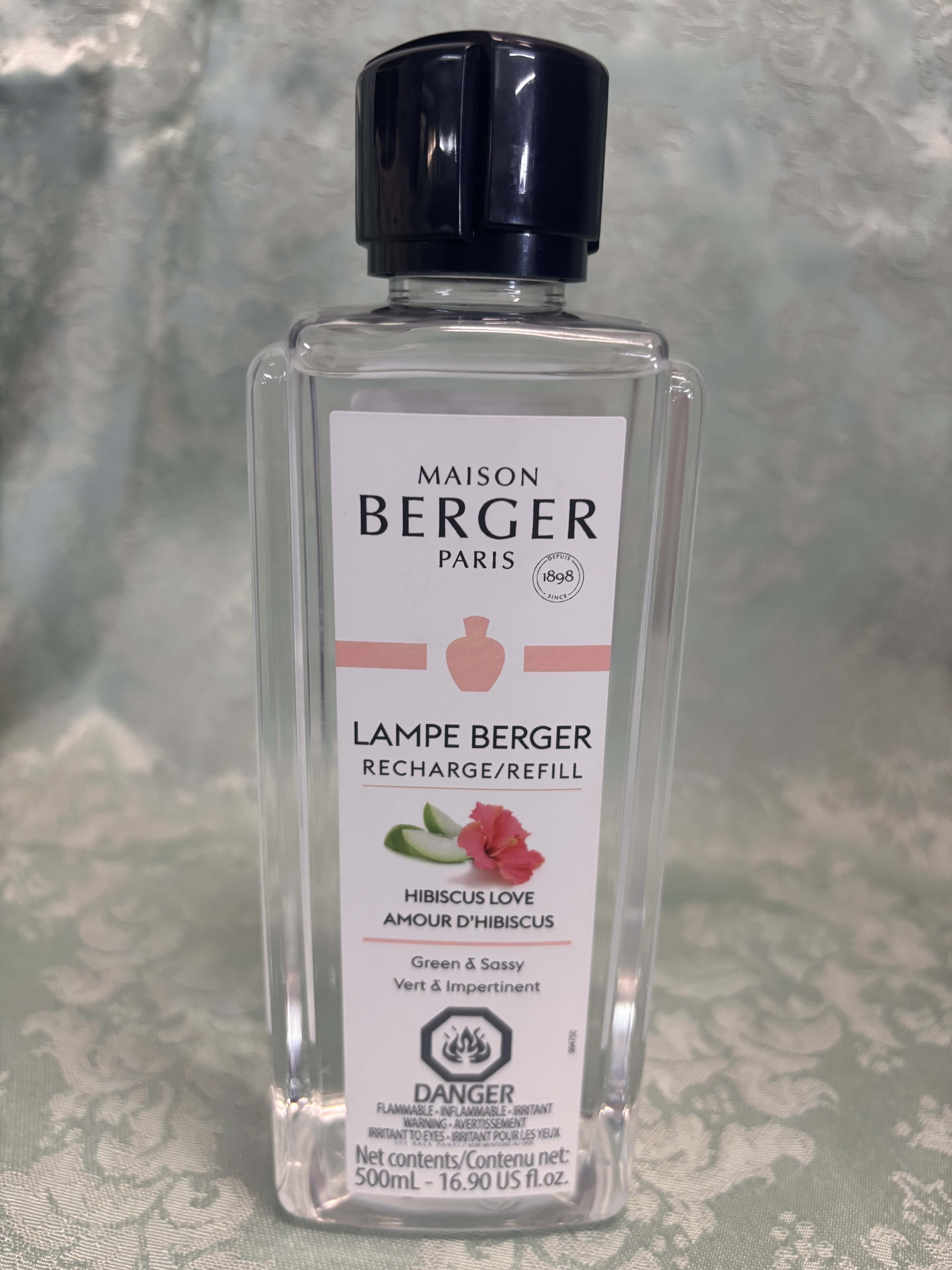 Clear bottle of Maison Berger Lampe Berger refill labeled Hibiscus Love